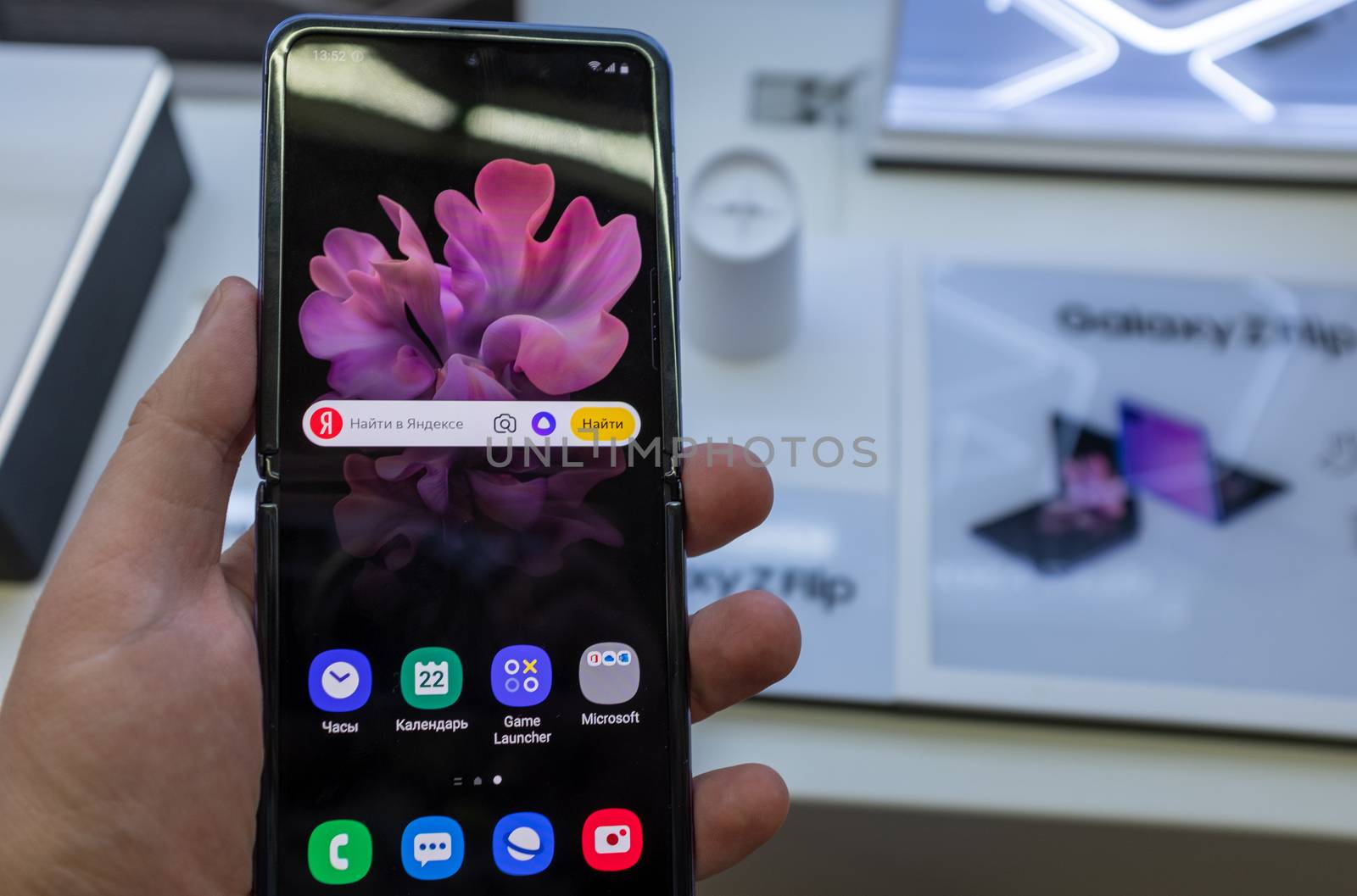 February 22, 2020, Moscow, Russia. New folding smartphone with a folding screen Samsung Galaxy Z Flip on the store counter.