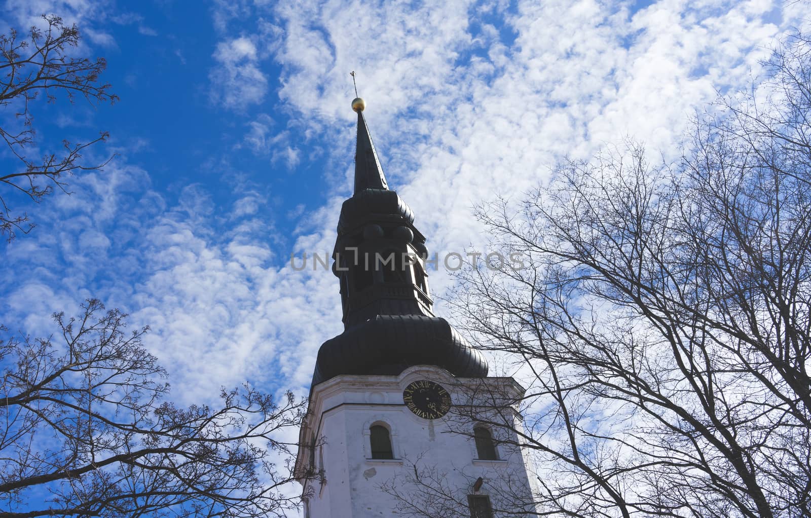 The tower of the St. Mary's Cathedral (Dome Church) in Tallinn on blue sky background with clouds.