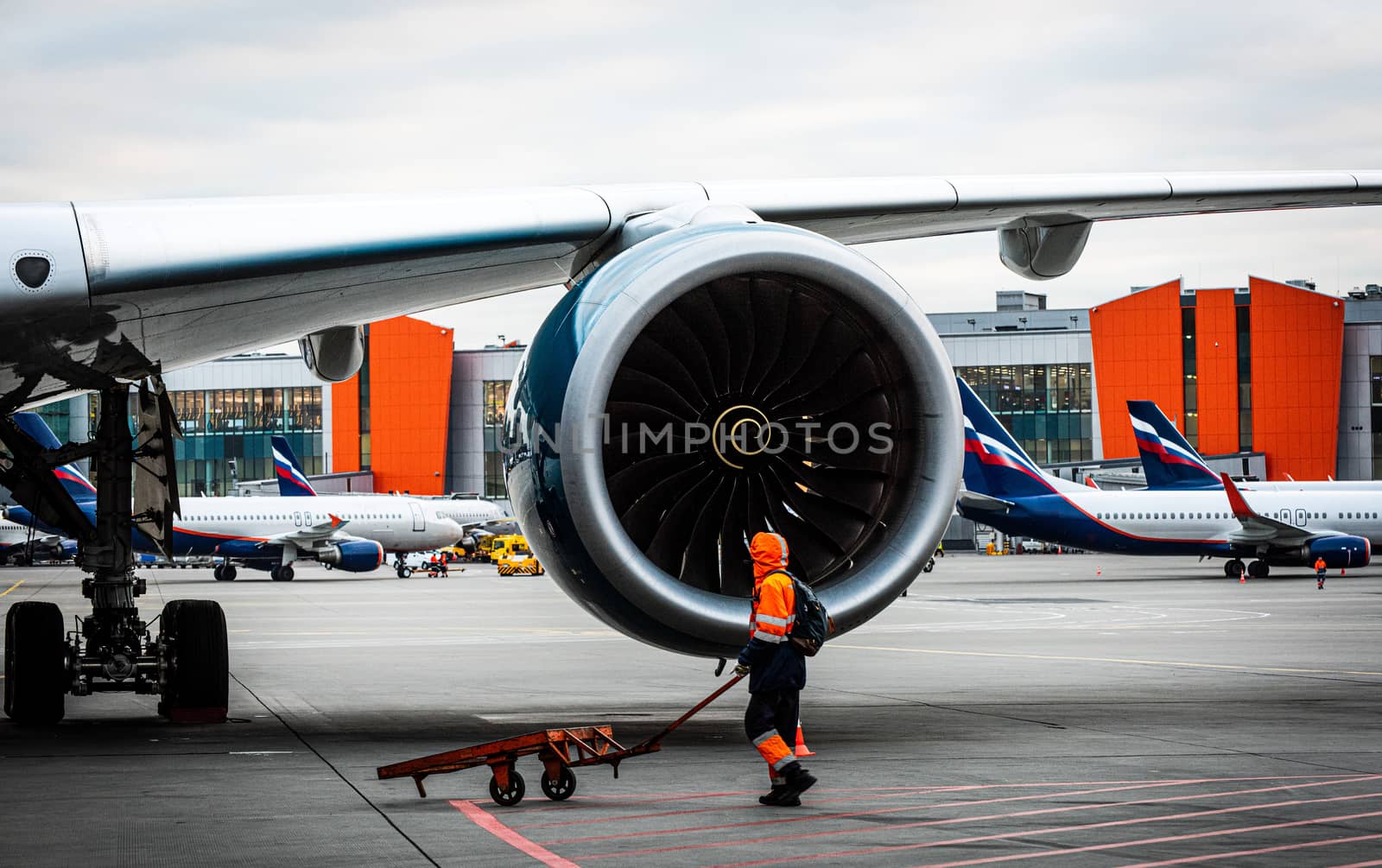 October 29, Moscow, Russia, Airport employee at the engine Rolls-Royce Trent XWB of a wide-body aircraft Airbus A350 XWB at Sheremetyevo Airport.