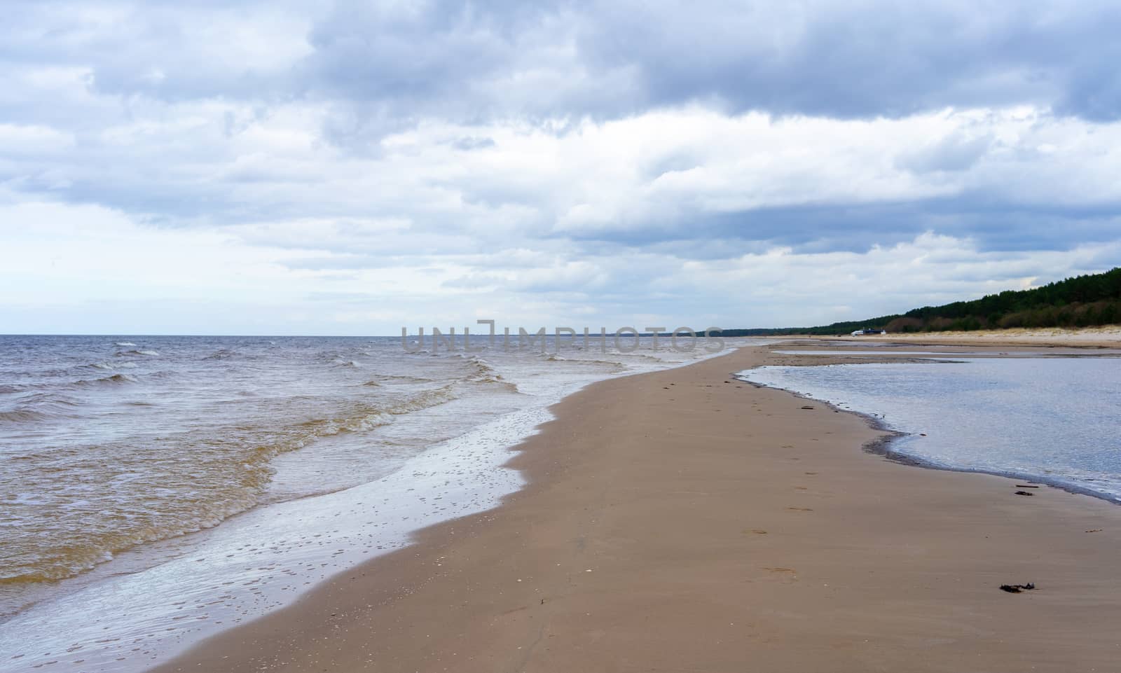 Clouds on a cloudy sky over the sandy beach of the Baltic Sea in Jurmala