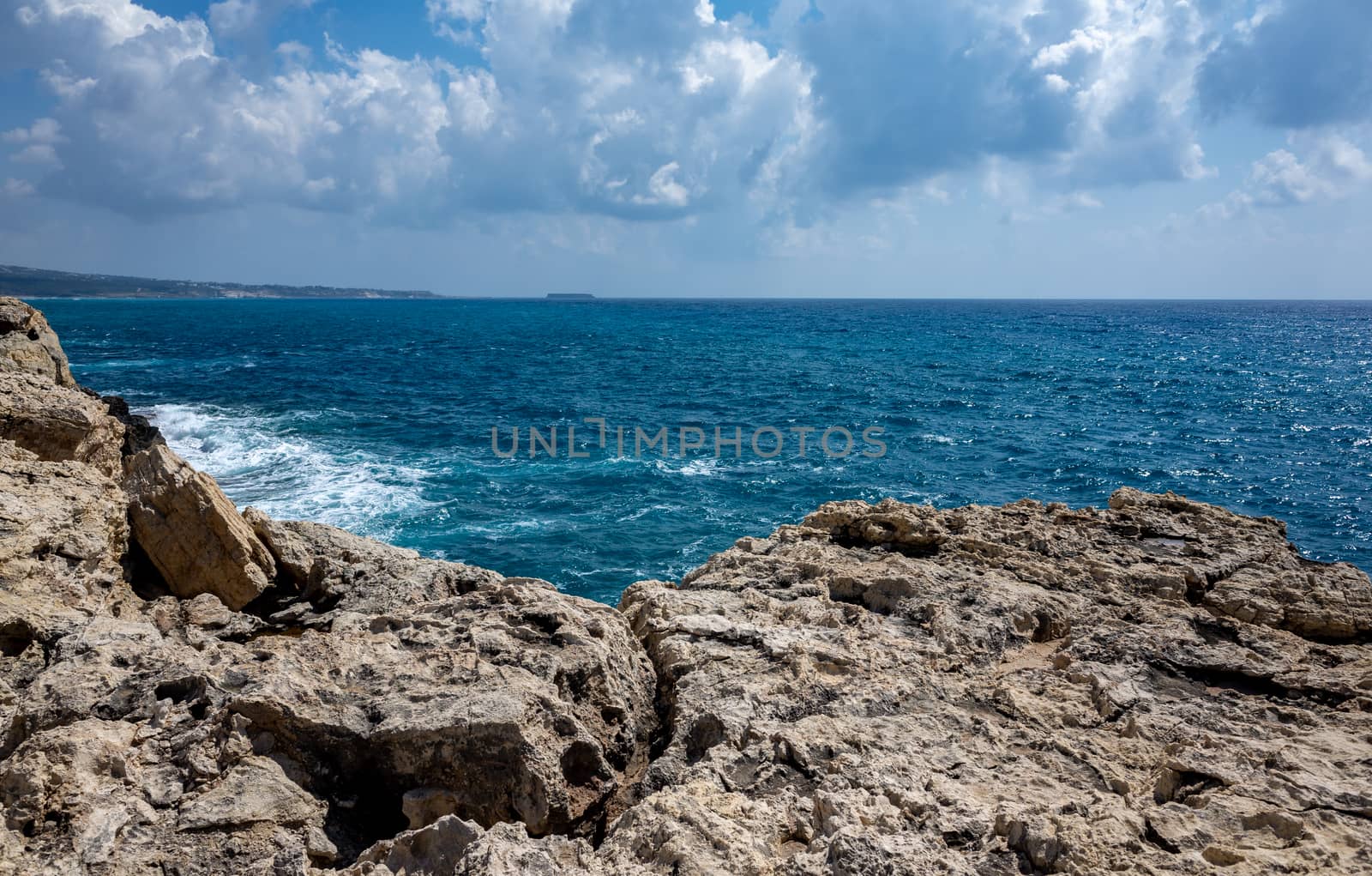 Waves crash on the rocky shore of the Mediterranean Sea on the Akamas Peninsula in the northwest of the island of Cyprus.