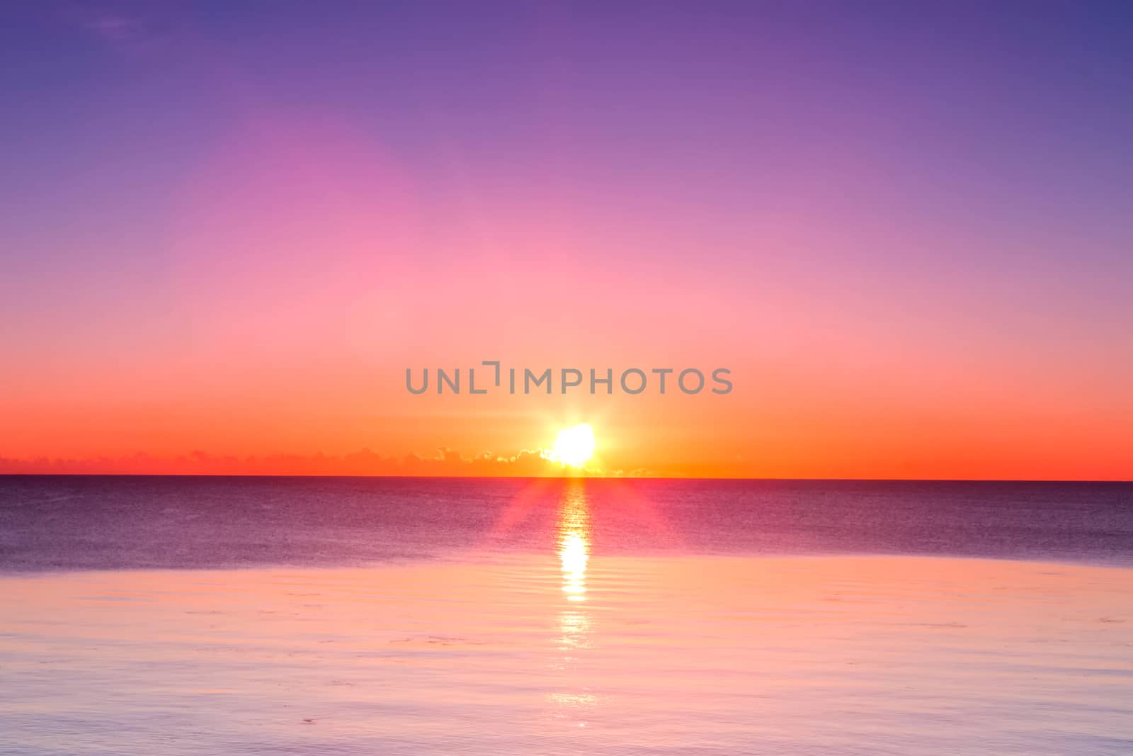 Sunset over the sea. Full calm at sea at sunset.
