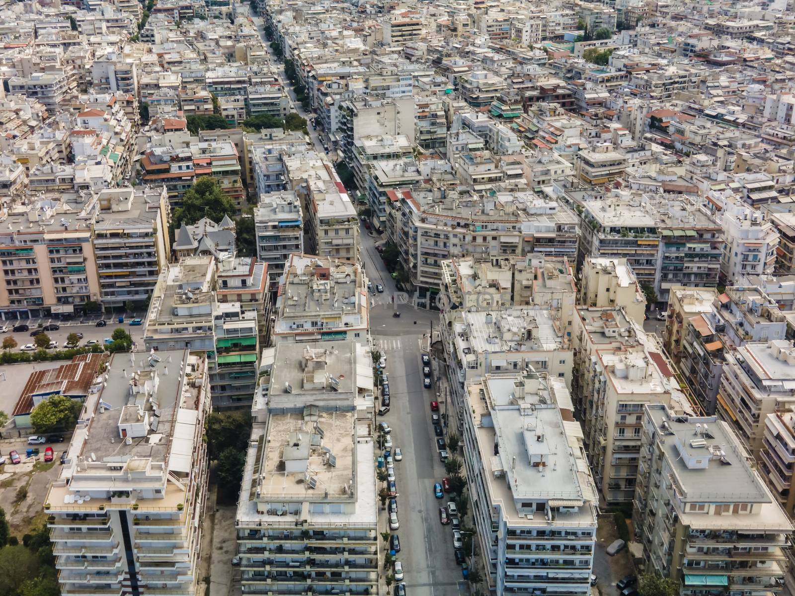 Day top panorama of European city with residential blocks of flats around road on a sunny day.