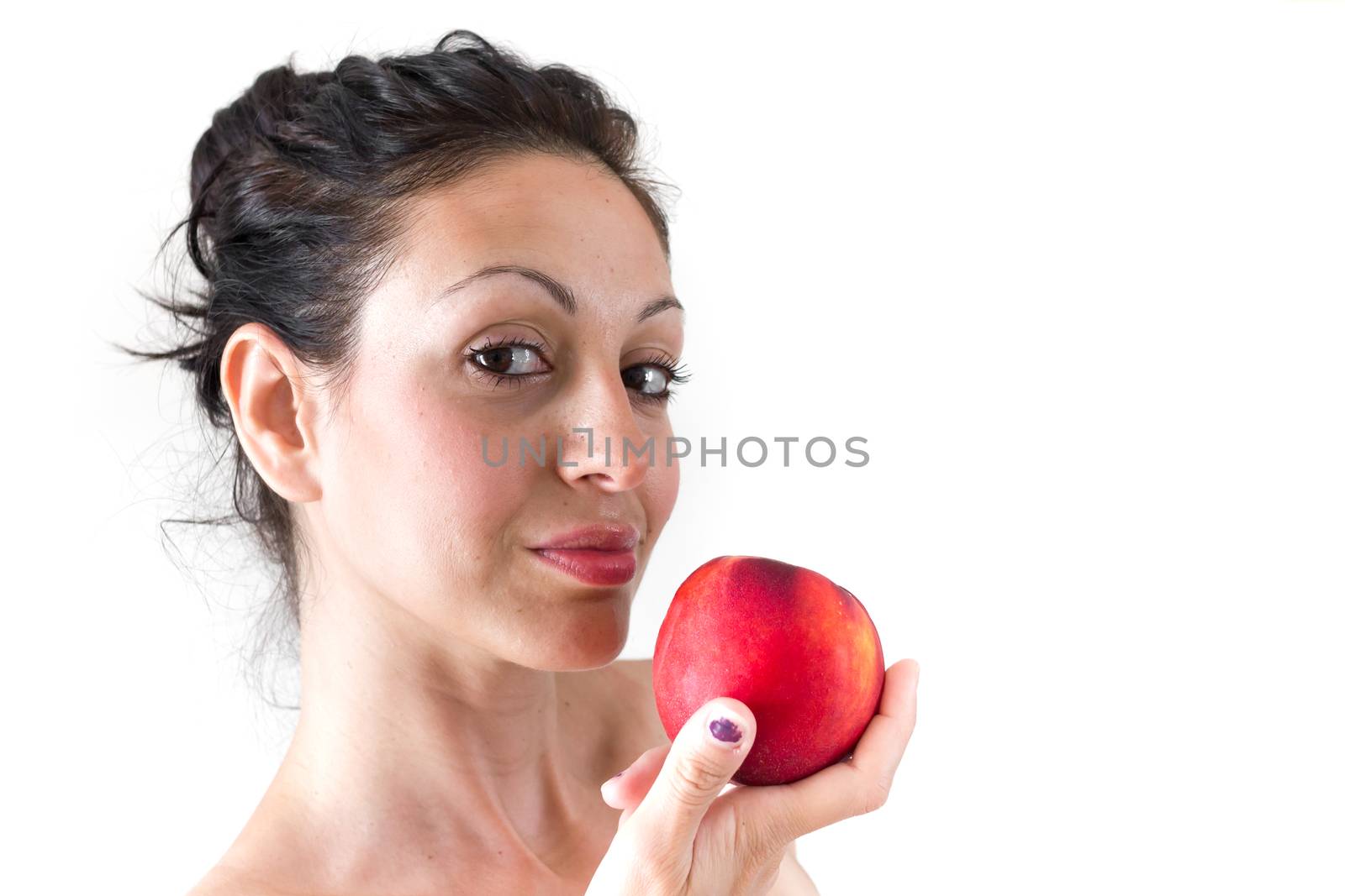 A girl while eating a peach, isolated on white background.