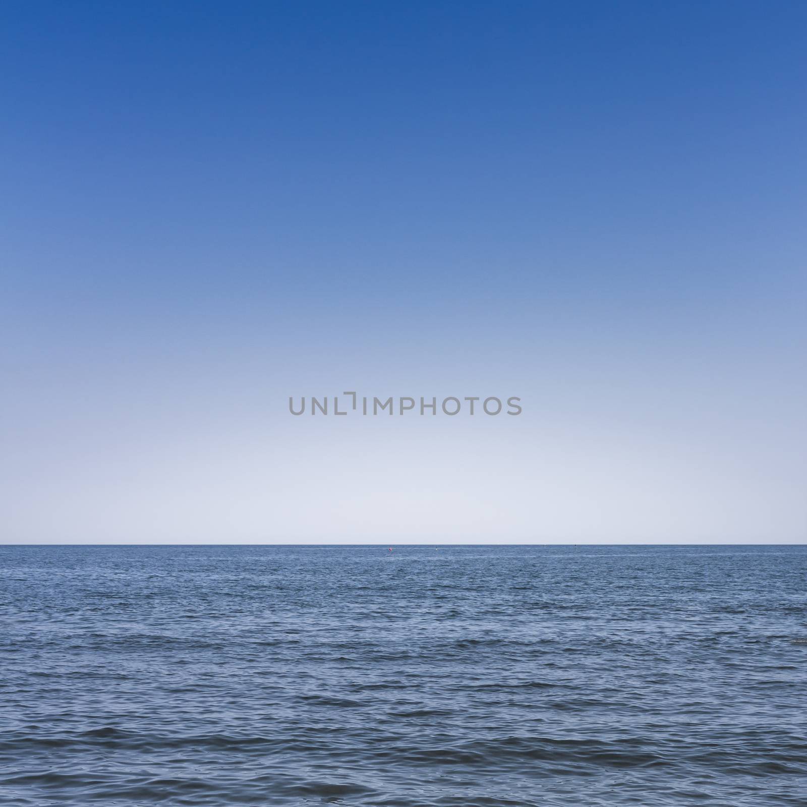 Front view of the sea with blue sky in the background.