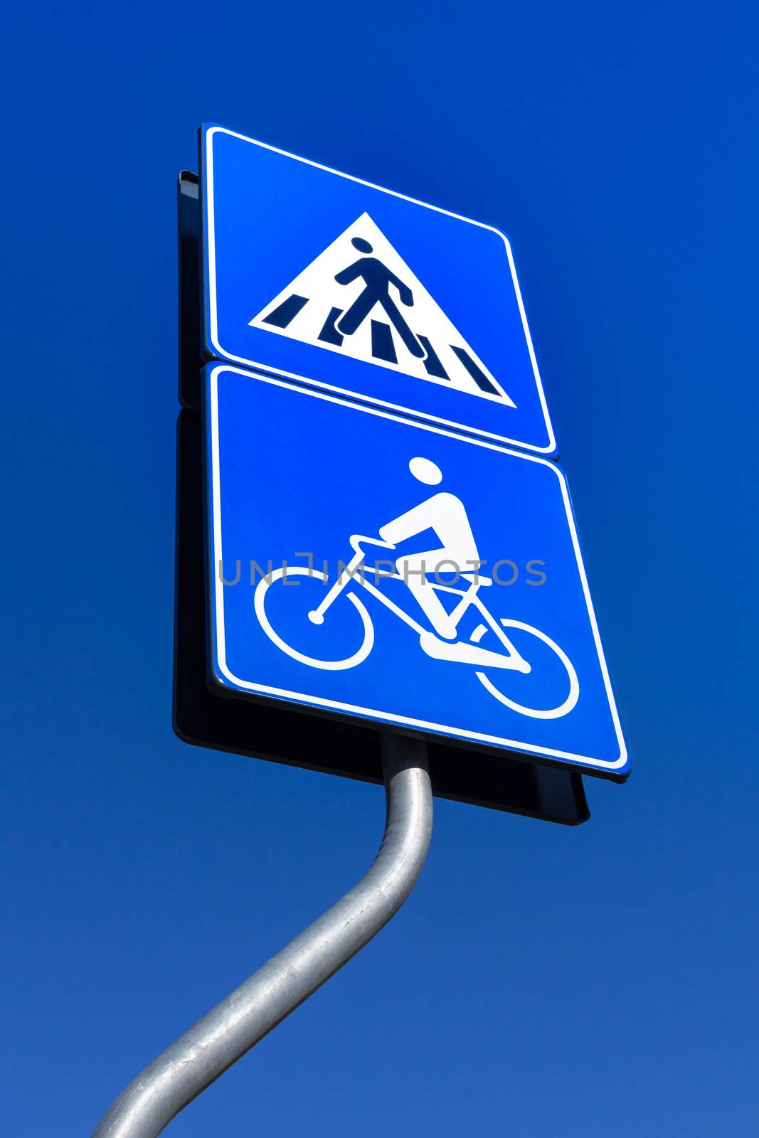 Road sign warns about pedestrian crossing and bicycle road