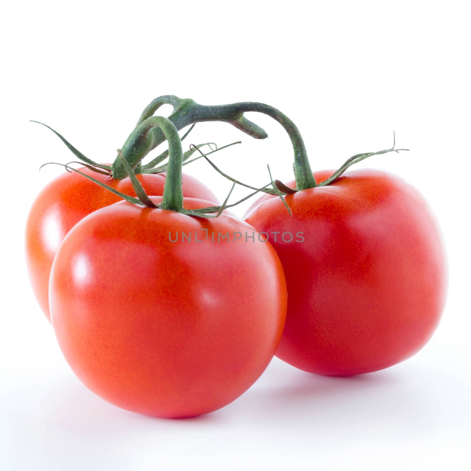 Three red tomatoes isolated over white background.