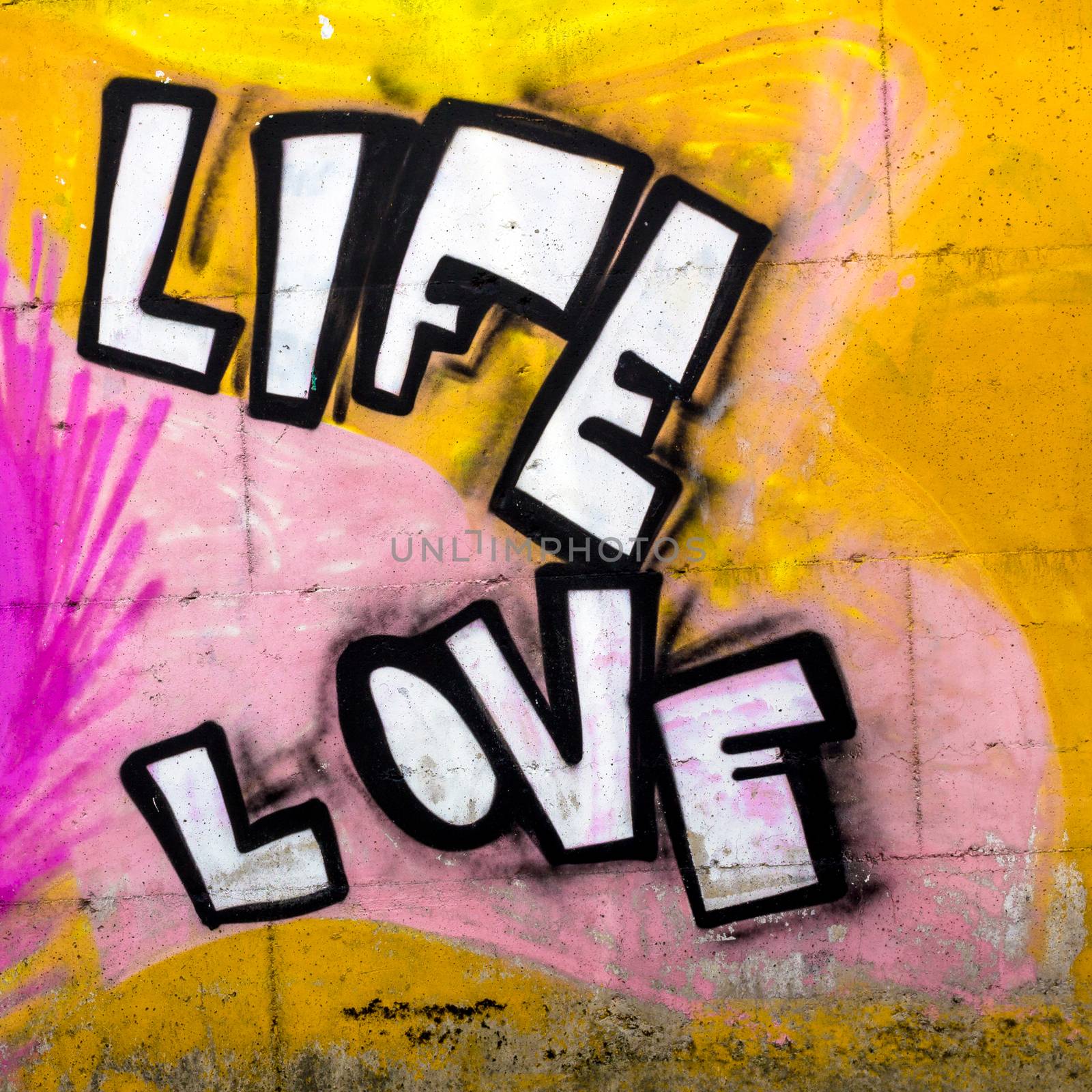 The words LIFE and LOVE sprayed onto a wall by germanopoli