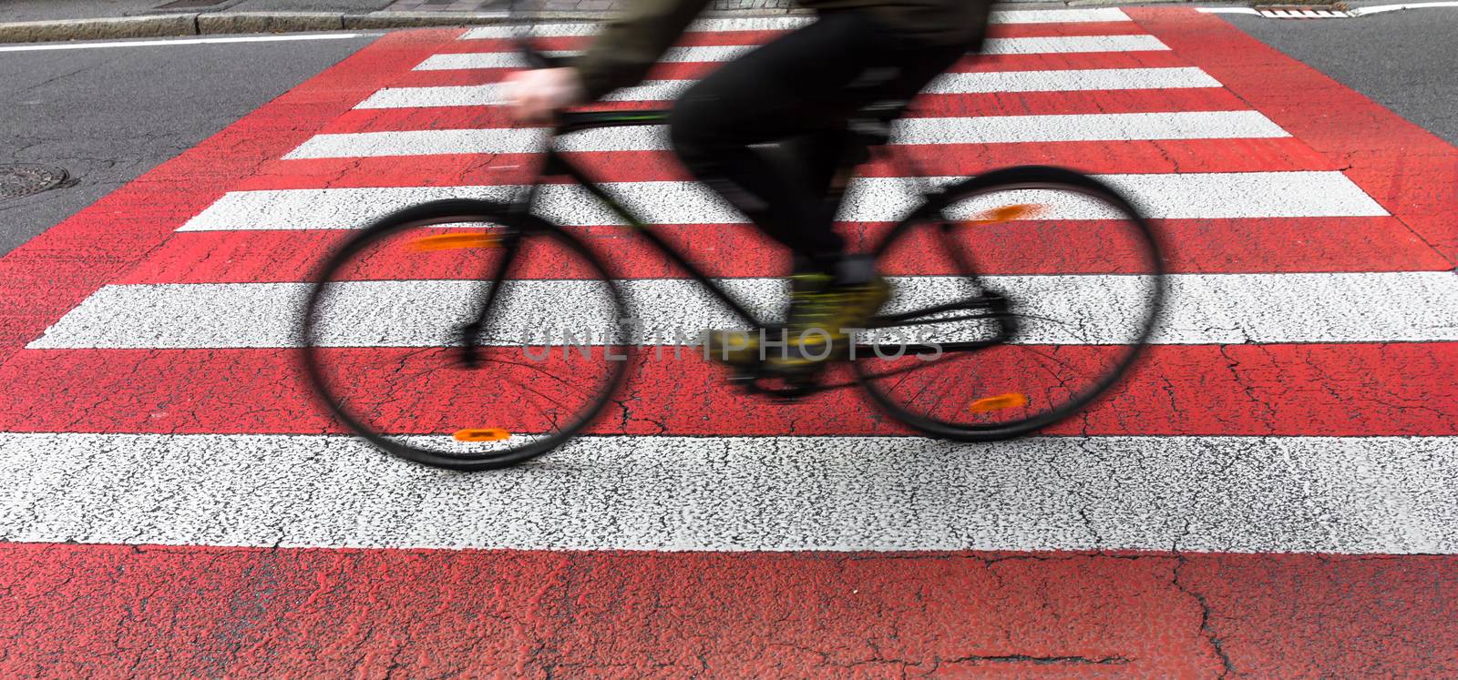 Cyclist on bicycle crossing the street