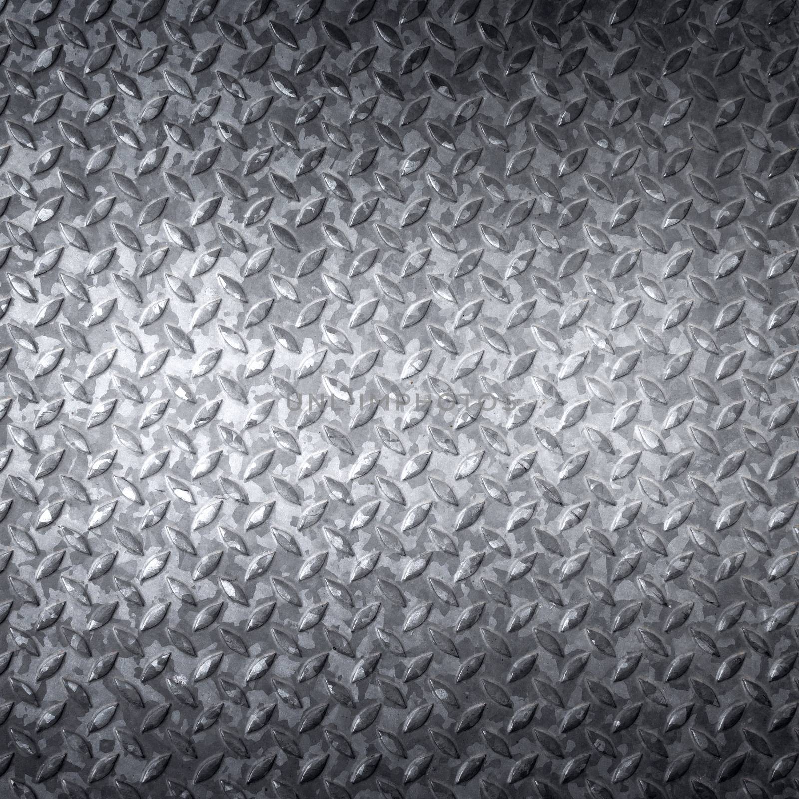 Aluminum dark list with rhombus shapes; industrial texture for background.