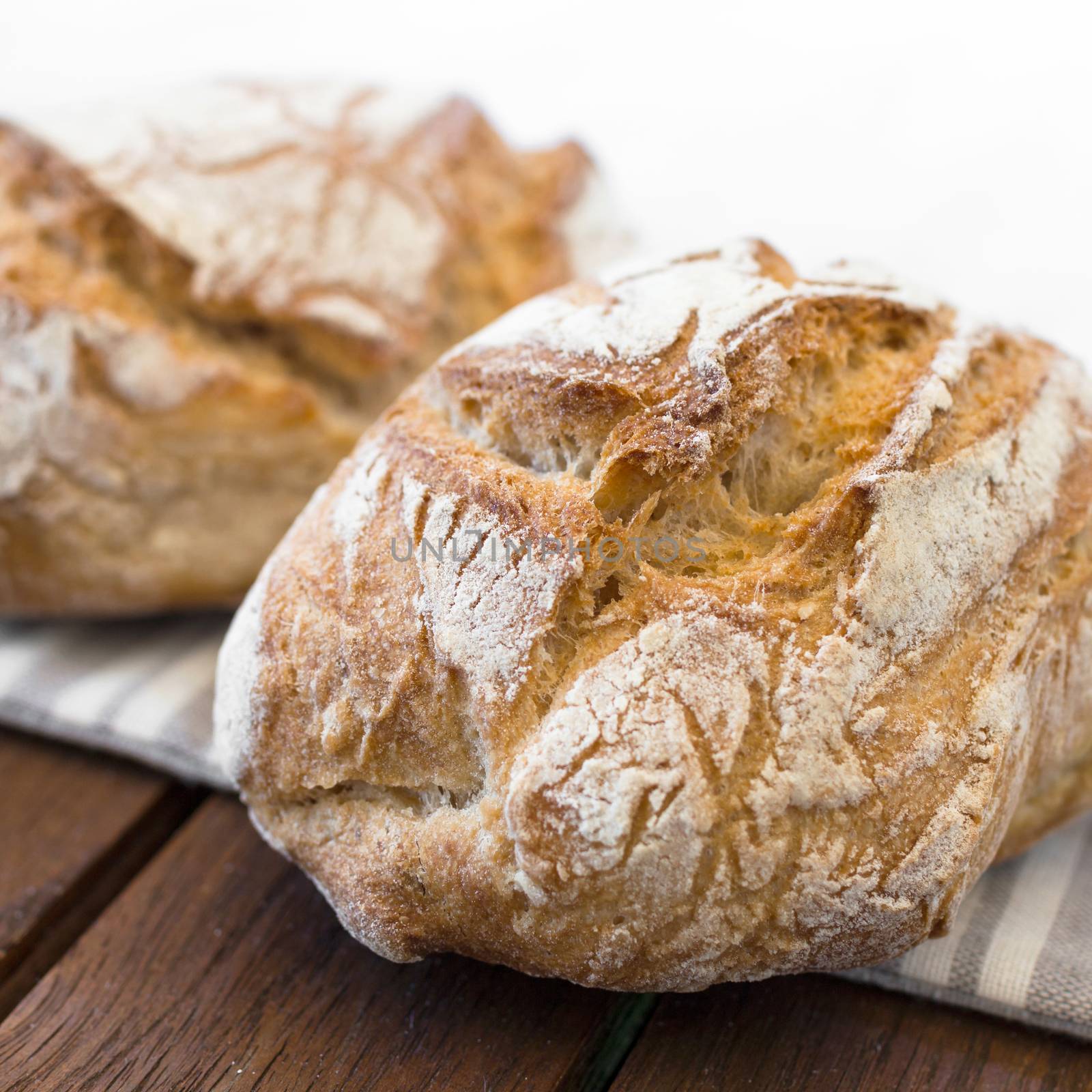 Handmade tasty bread lying on burlap on the wooden table