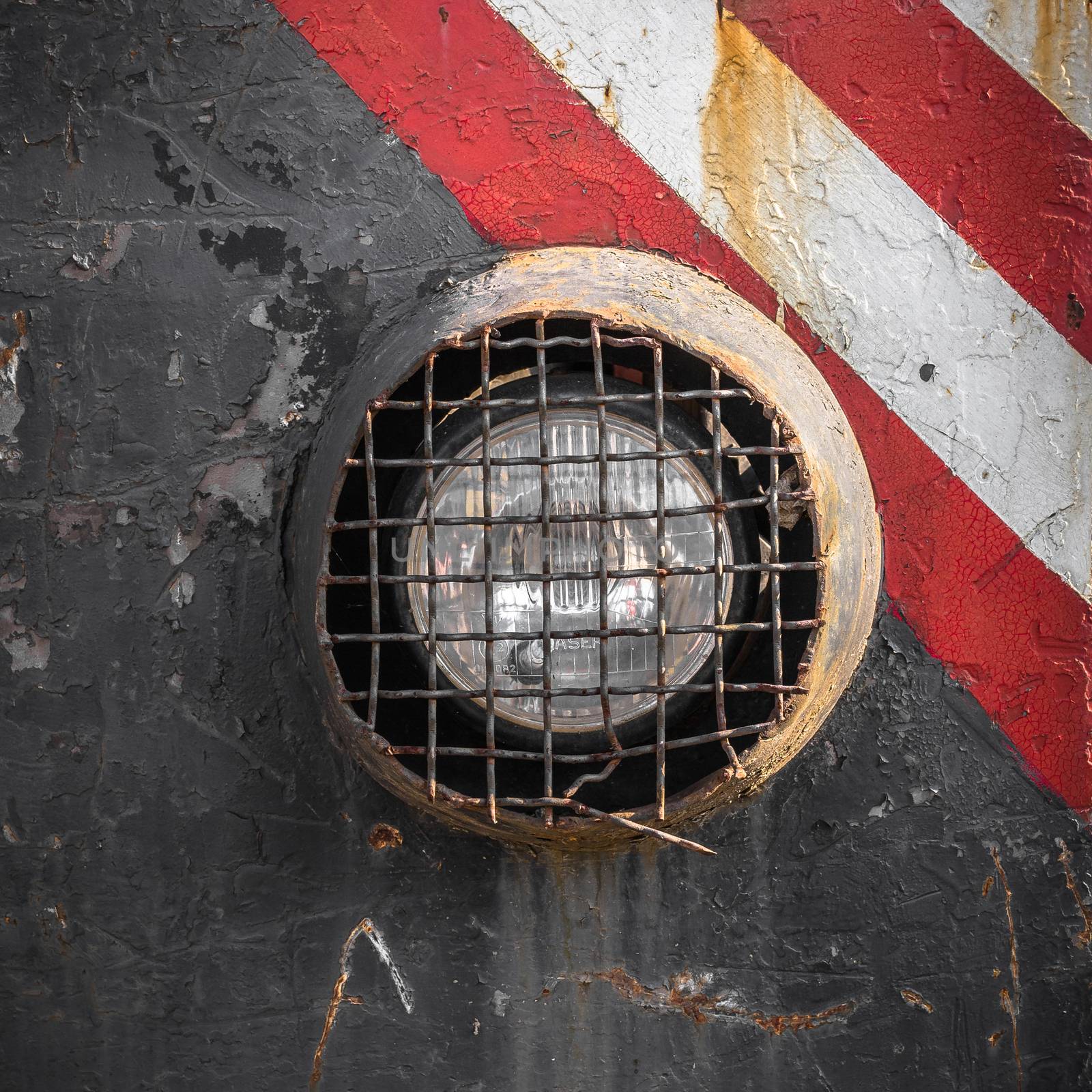 Headlight reinforced of an old rusty truck.