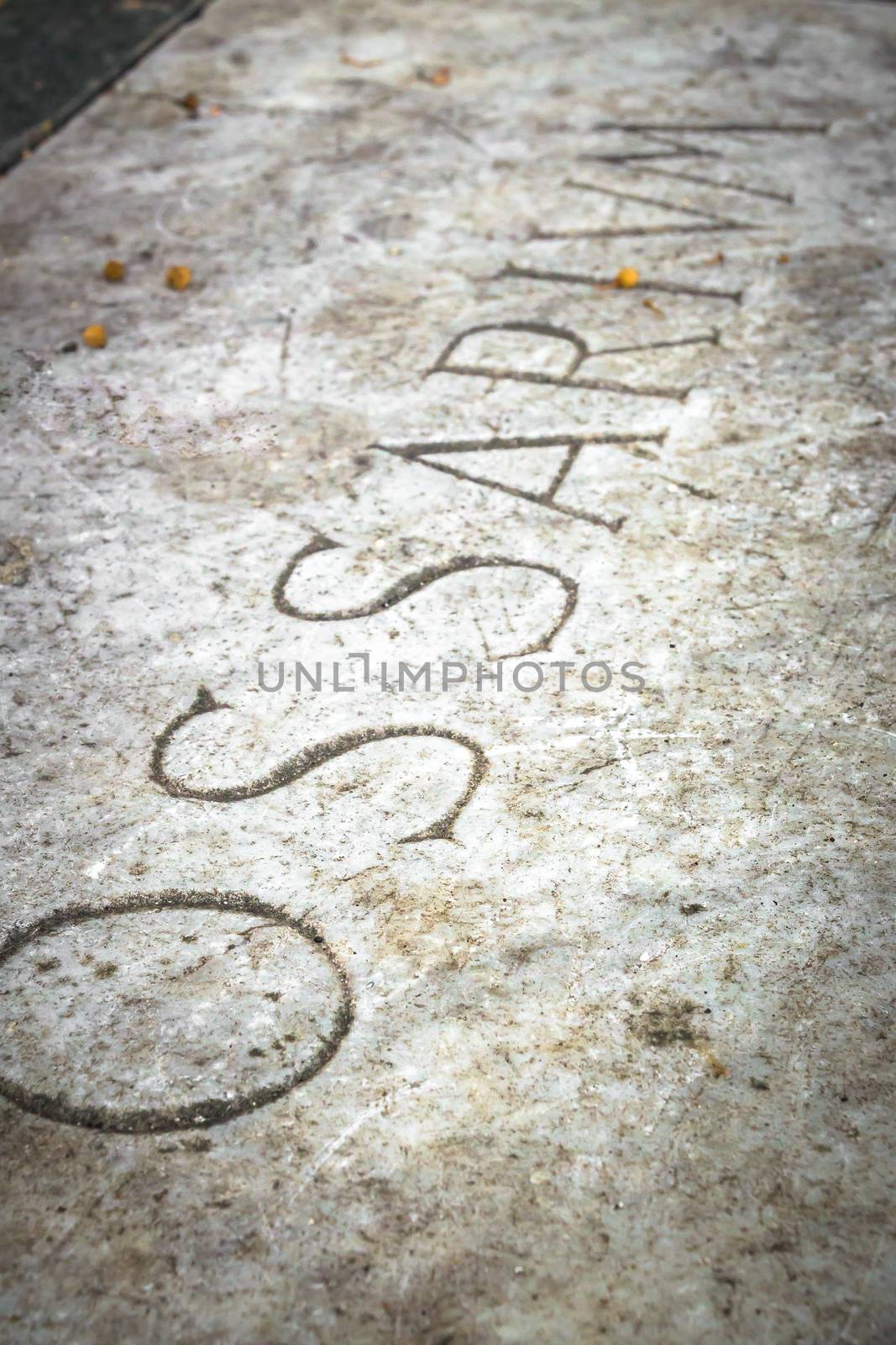 Burial urn with the engraving in Latin "Ossarium" (translation from Latin Ossario). Shallow depth of field.