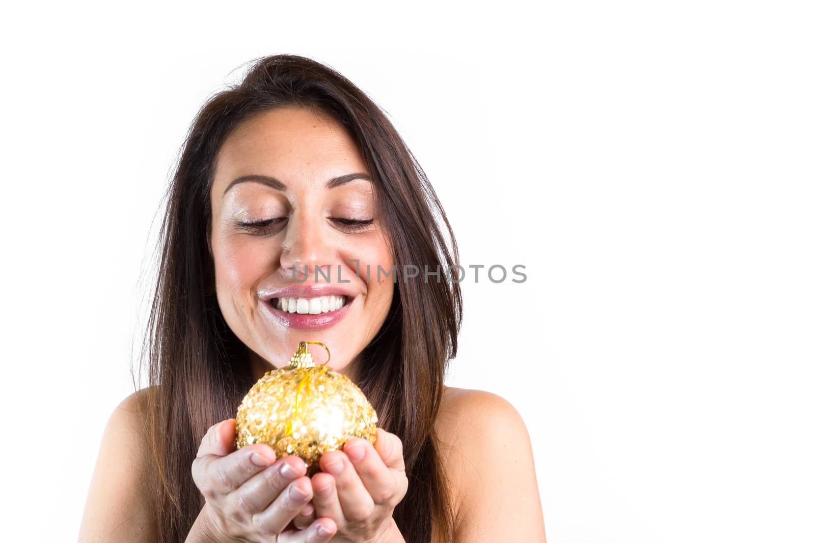 Christmas ball in hand of smiling woman over white. Christmas concept.