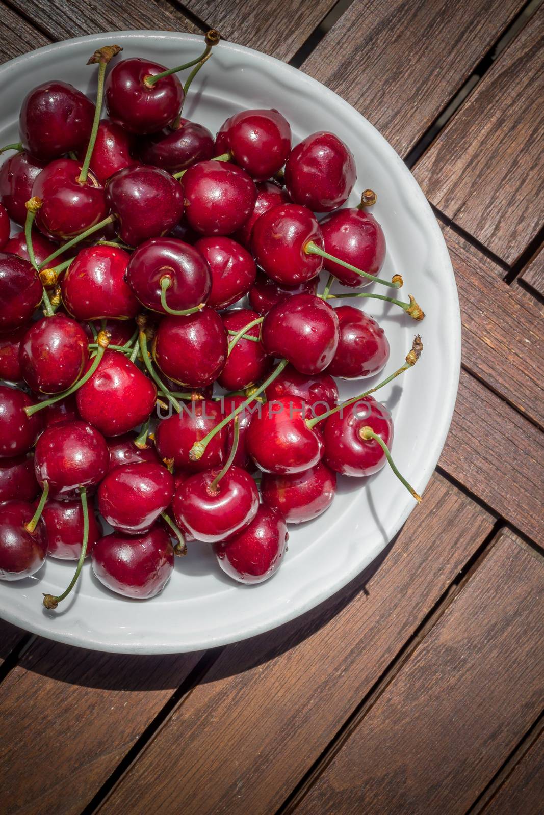 Ripe fresh rich cherries in the plate. Fruit background. Shallow DOF.