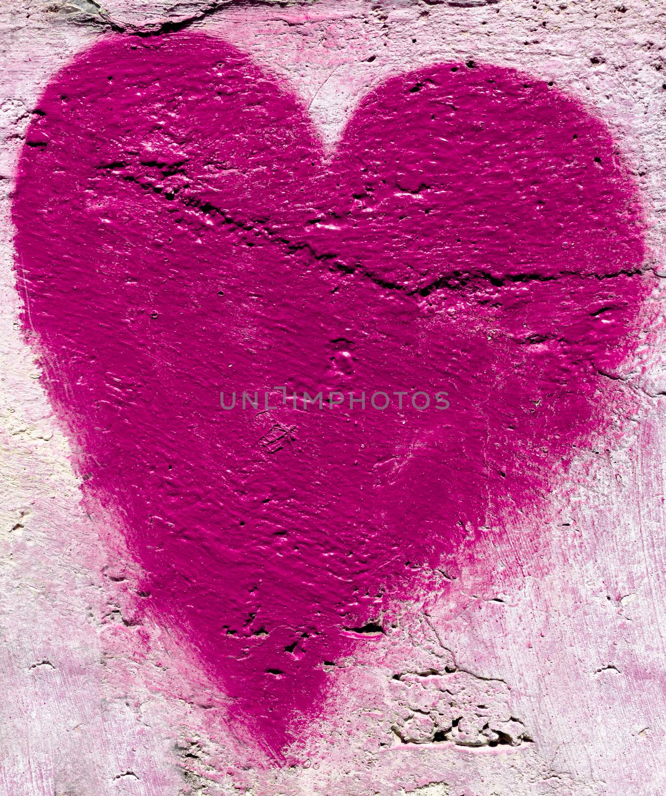 Pink heart on the wall by germanopoli