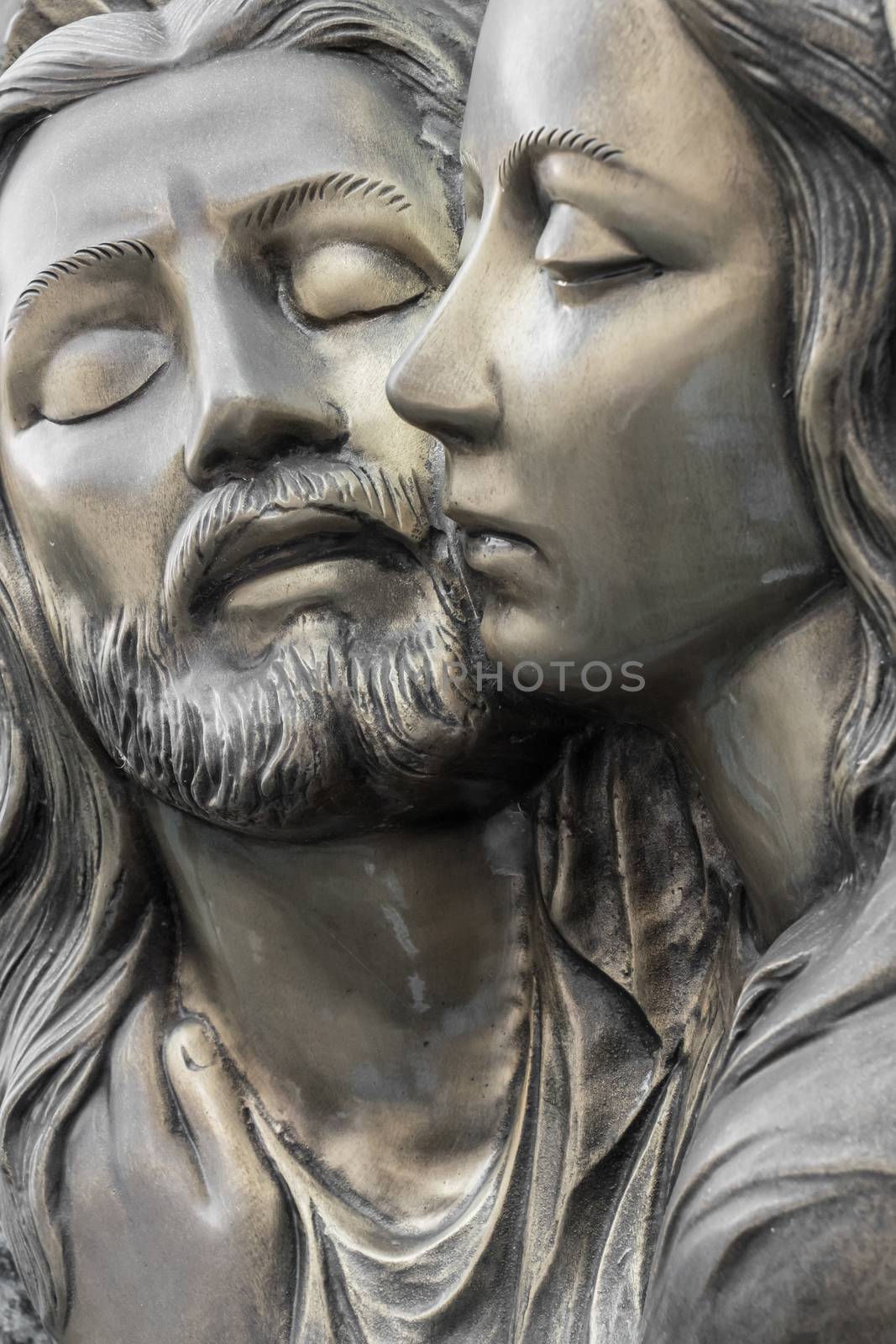 Bas-relief in bronze representing The Pity of Michelangelo. Faces of Holy Mary mother and Jesus Christ after the Crucifixion.