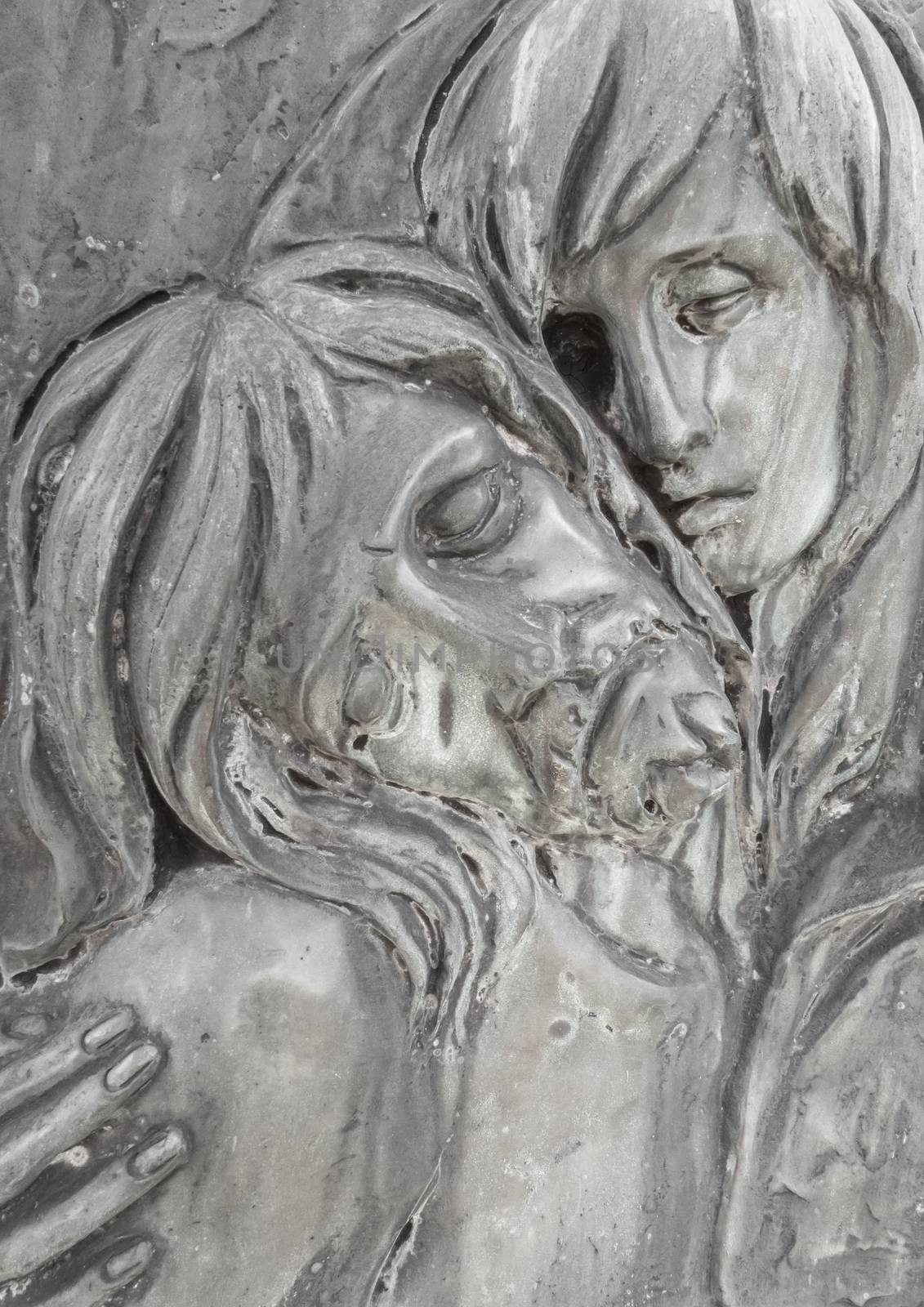 Bas-relief in bronze representing The Pity of Michelangelo. Faces of Holy Mary mother and Jesus Christ after the Crucifixion.