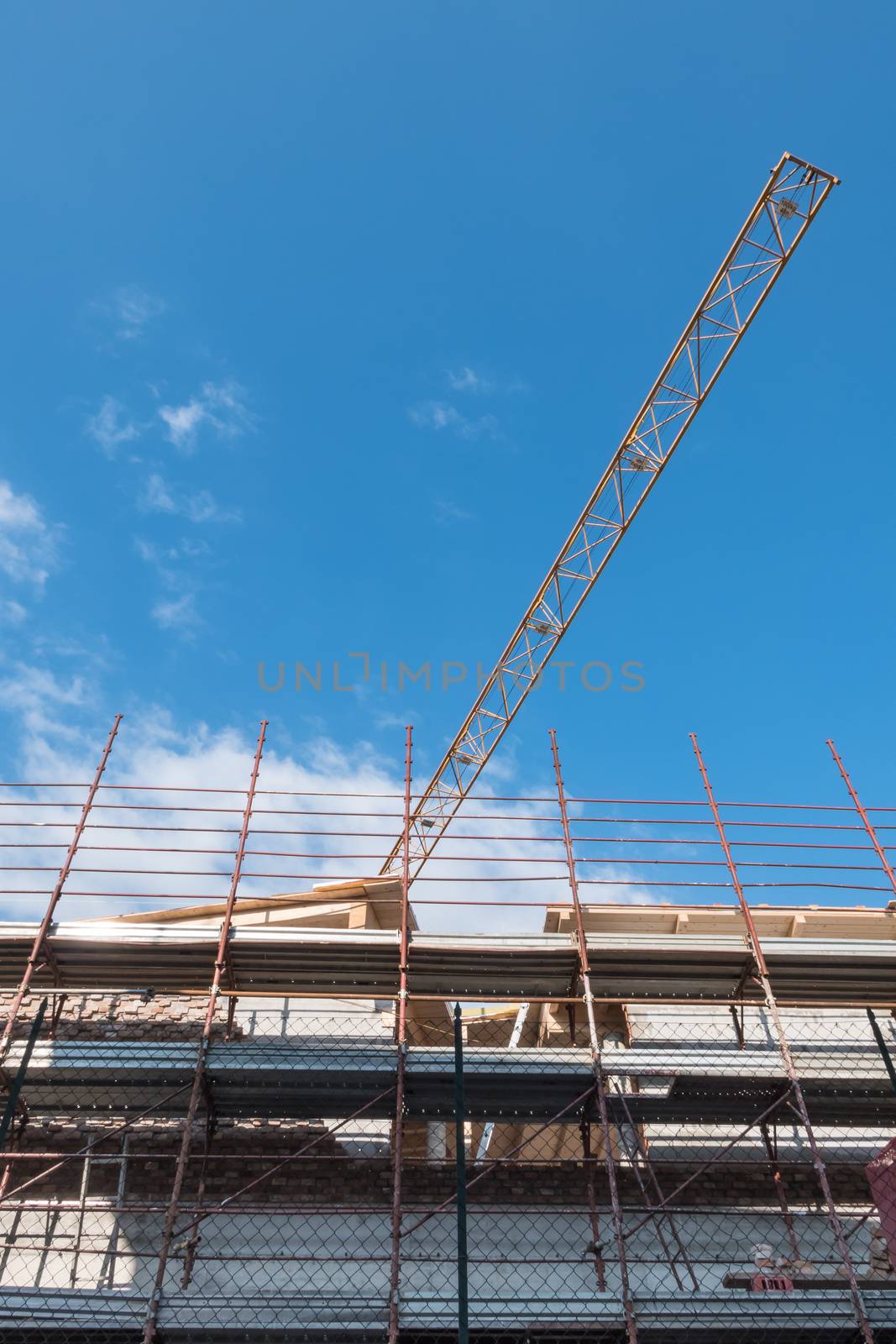 Building under construction with crane in a new residential area