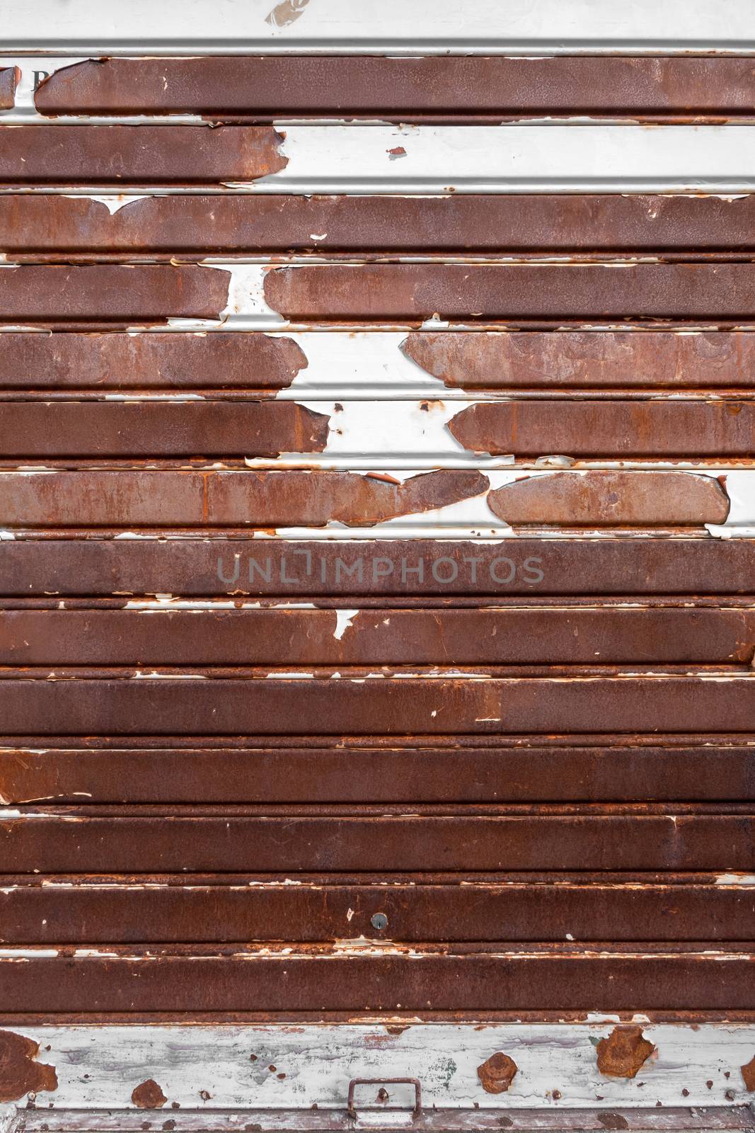 Old rusty garage shutter by germanopoli