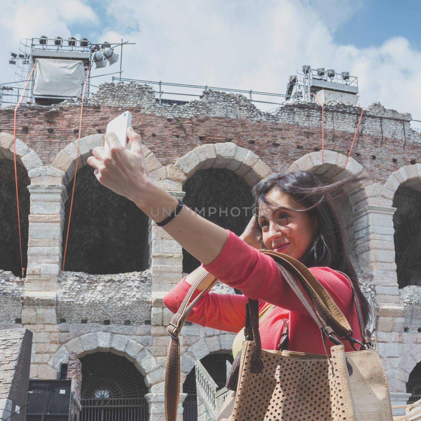 Young woman tourist taking selfie photo. Urban style.