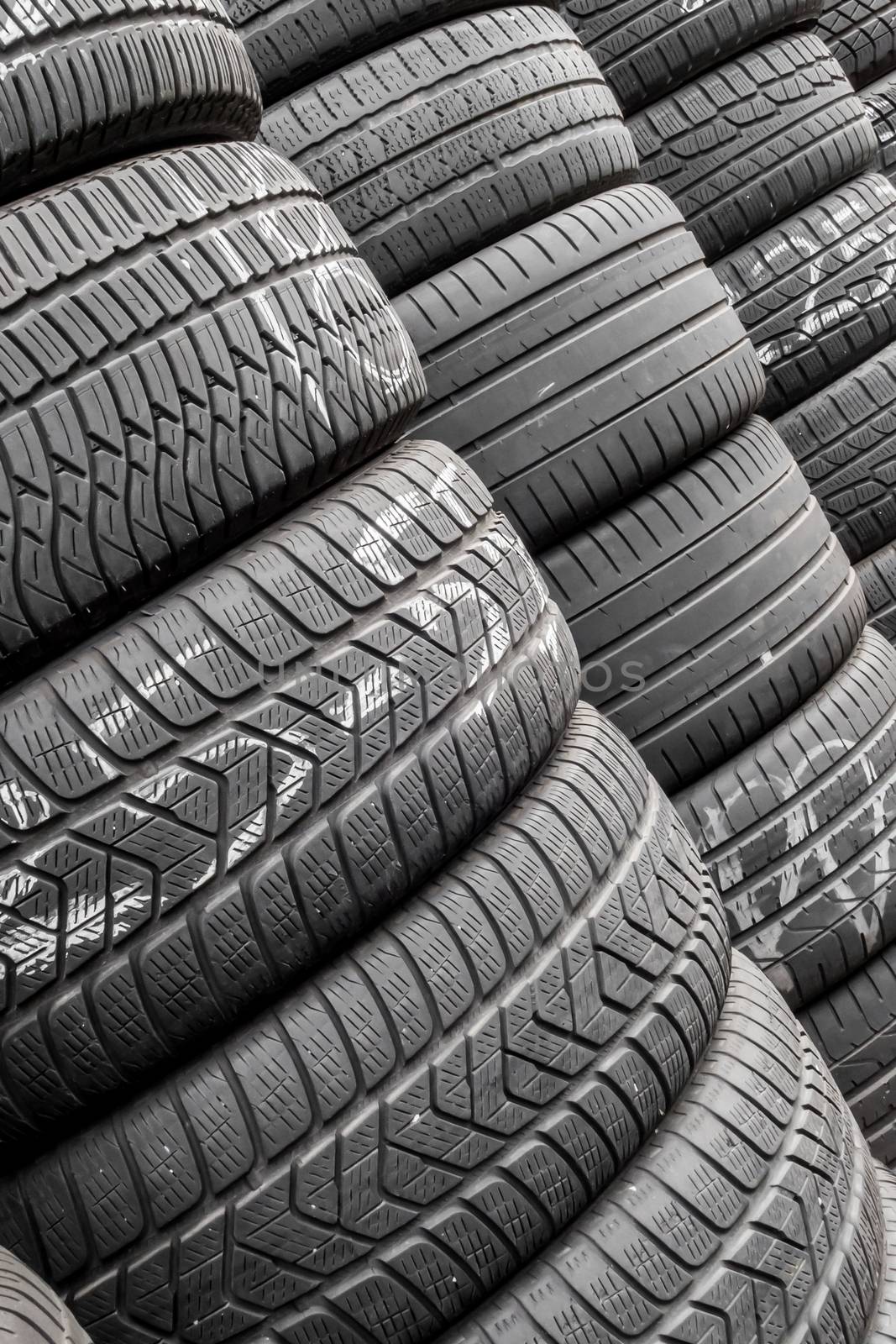 Stack of tires in a car shop by germanopoli