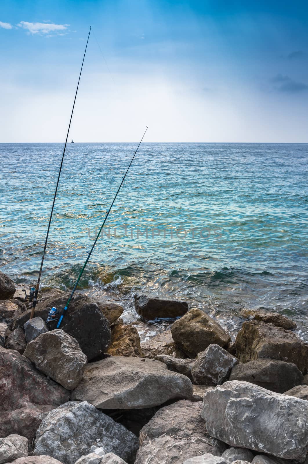 Two fishing rods on the cliff by germanopoli