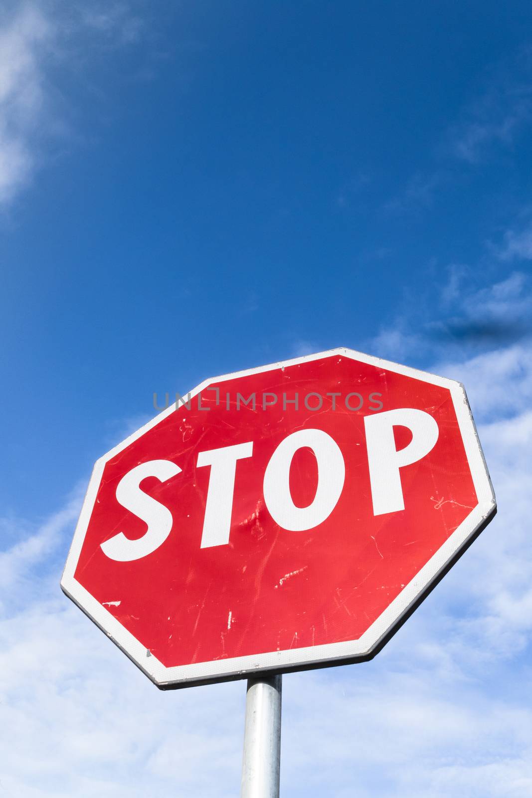 Stop sign against blue sky by germanopoli