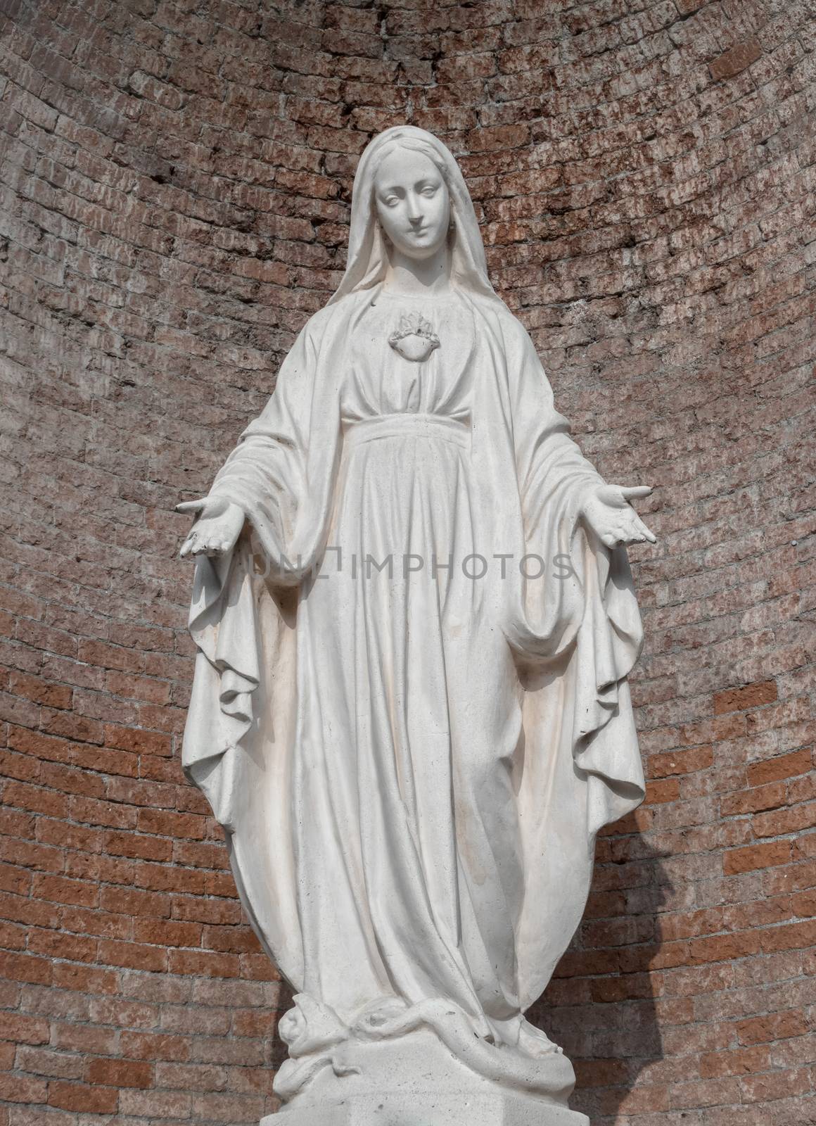 Statue in stone of Virgin Mary by germanopoli