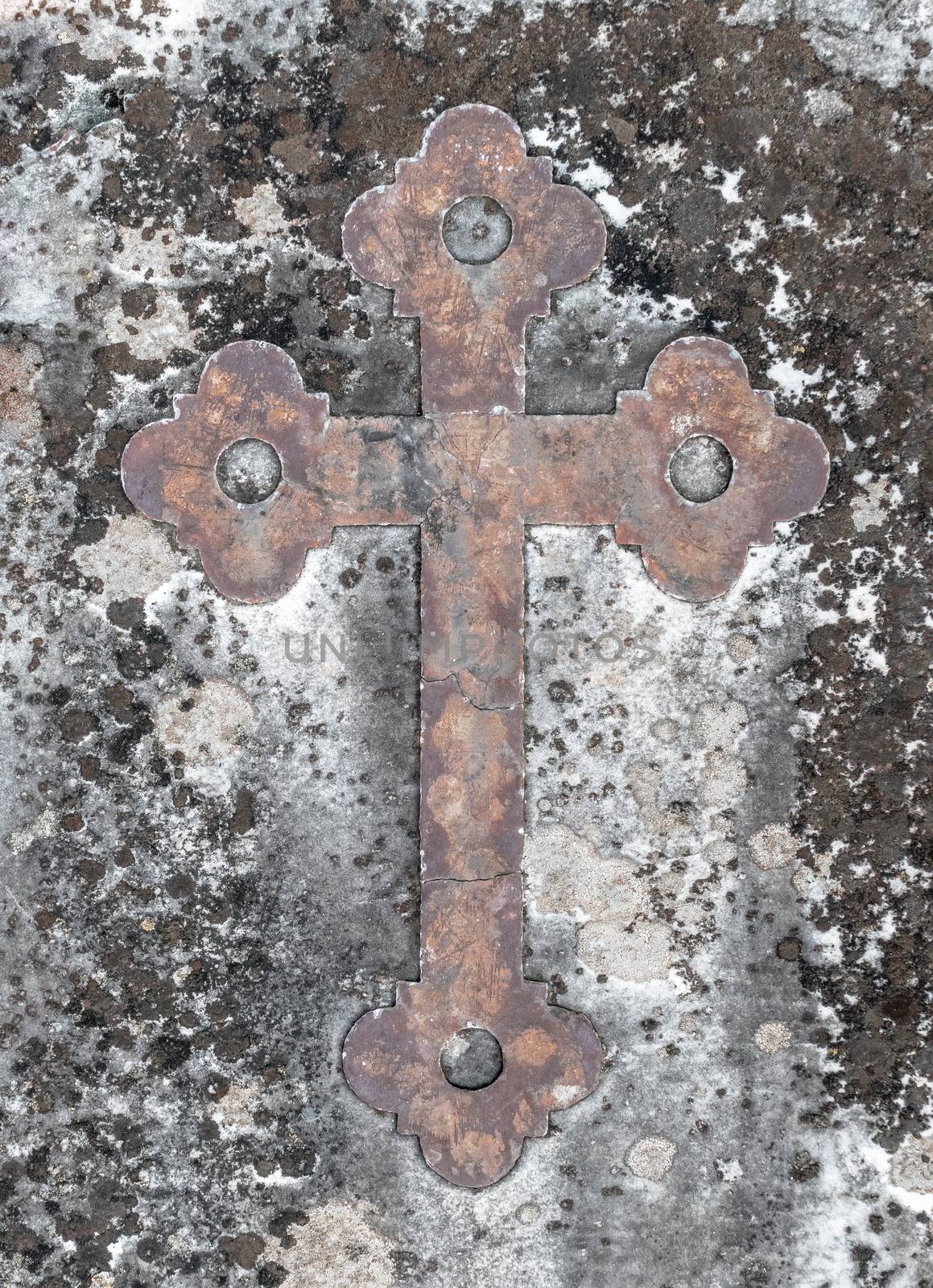 Ancient rusty cross on a old stone by germanopoli