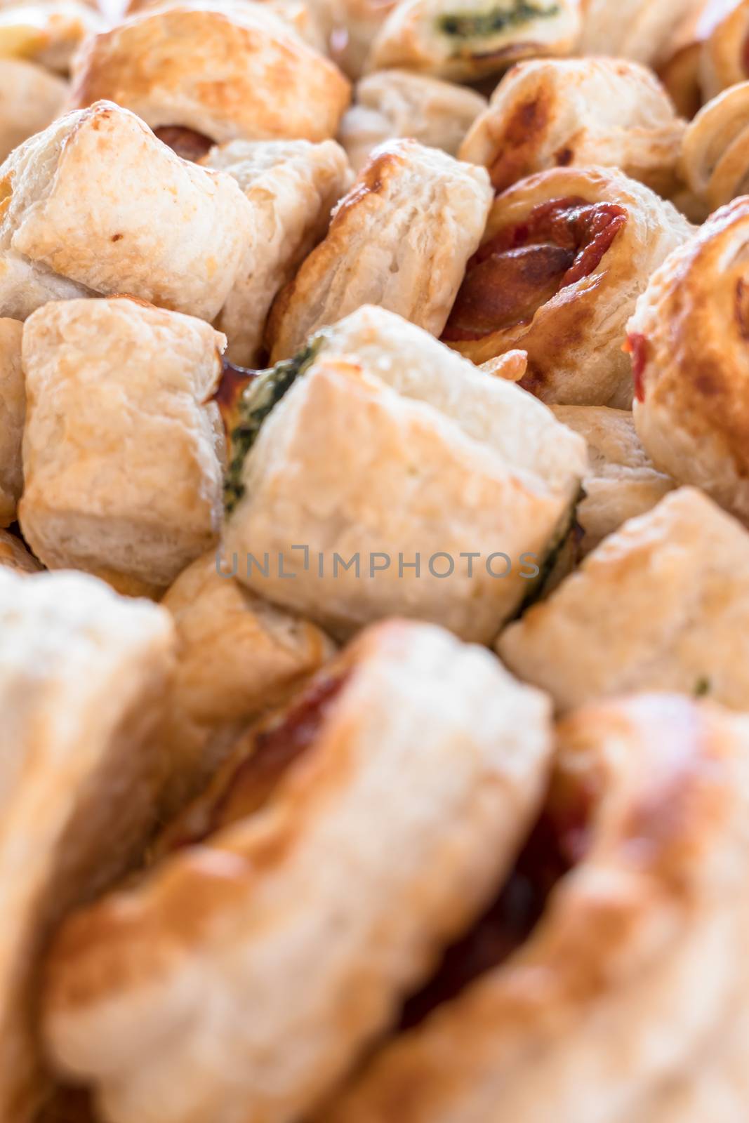 Mix of delicious appetizers. Small pizzas made of puff pastry. Selective focus