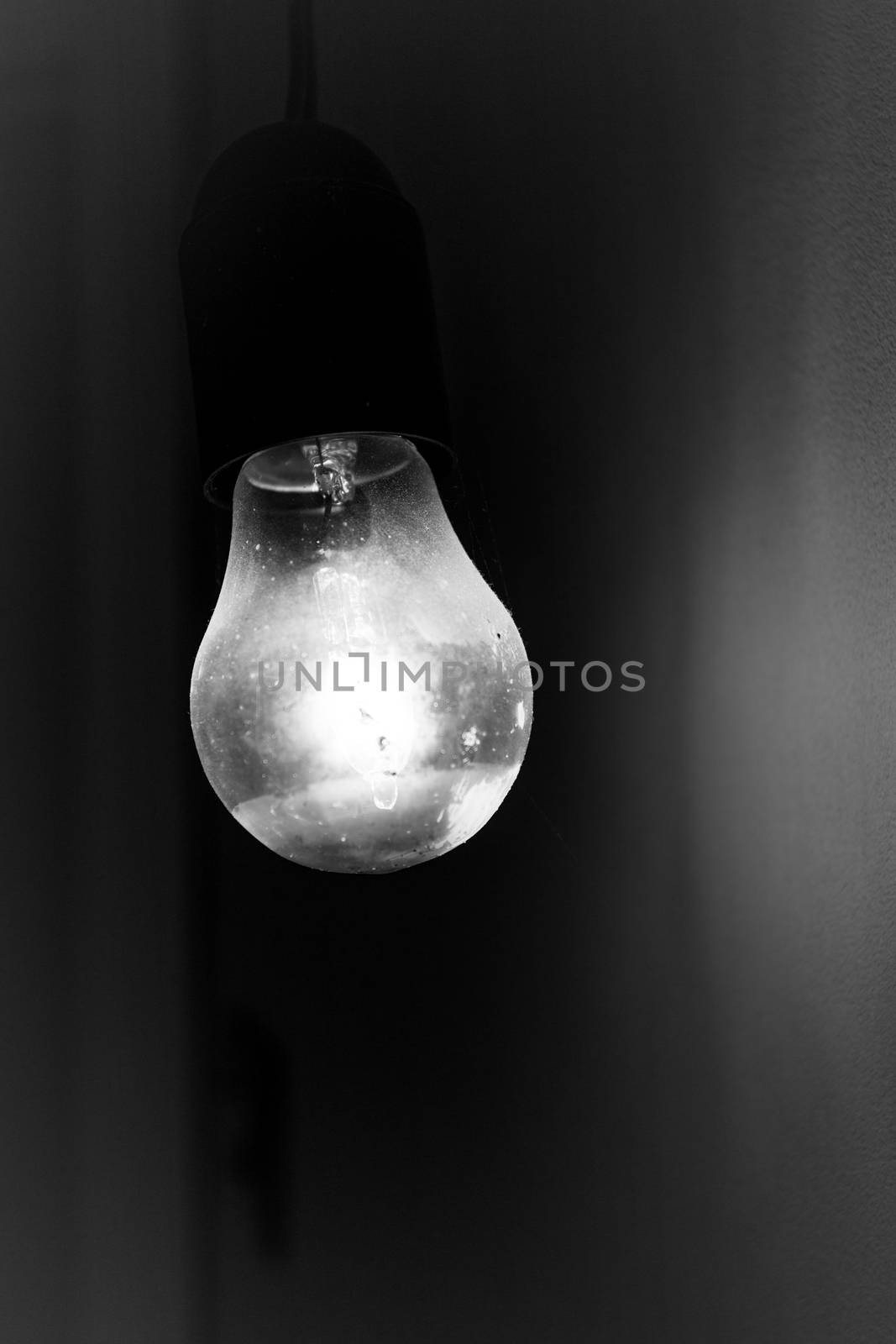 Old vintage light bulb glowing in the dark. Ideal for concepts.