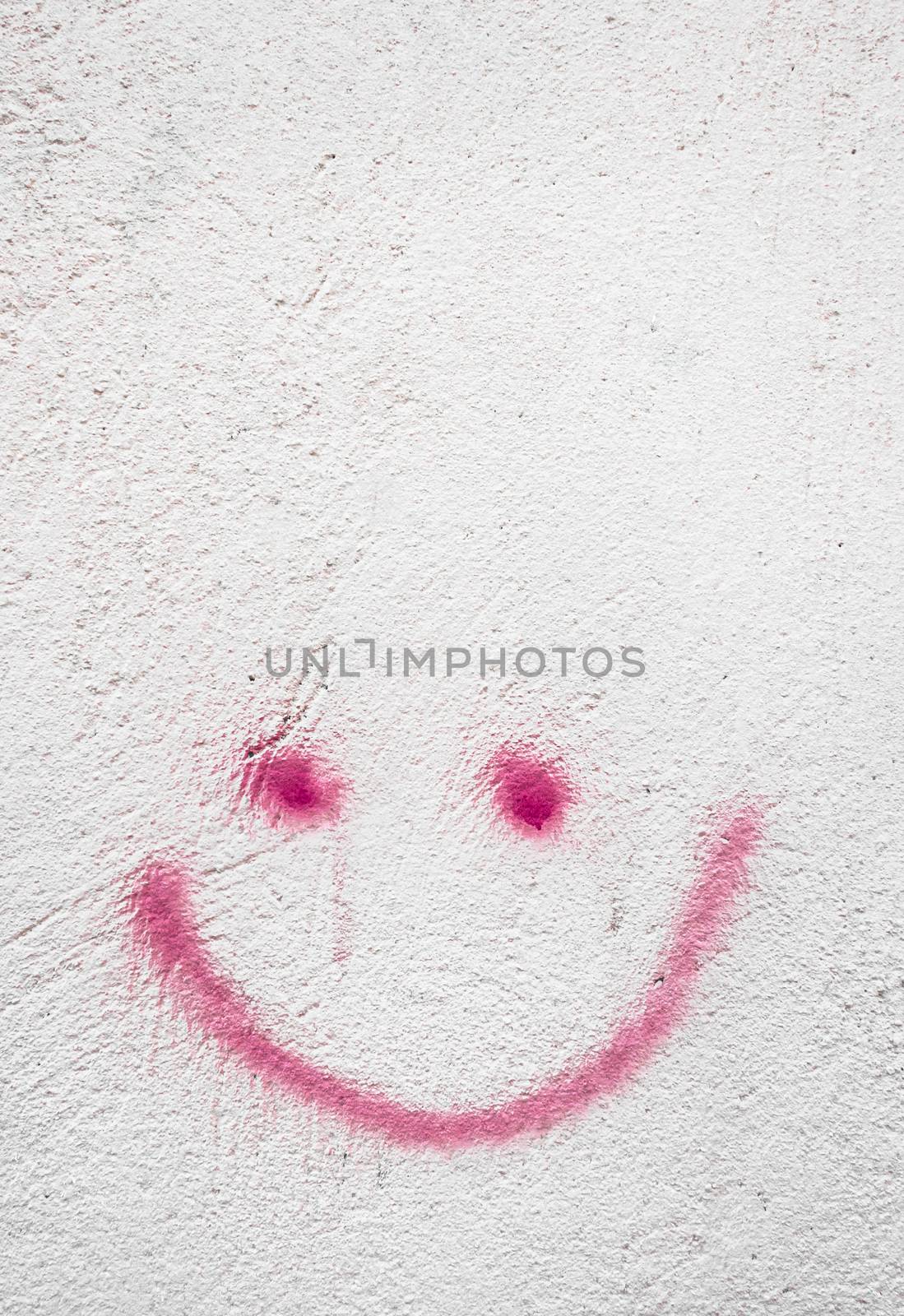 Concrete wall with red smiley, background for many uses.