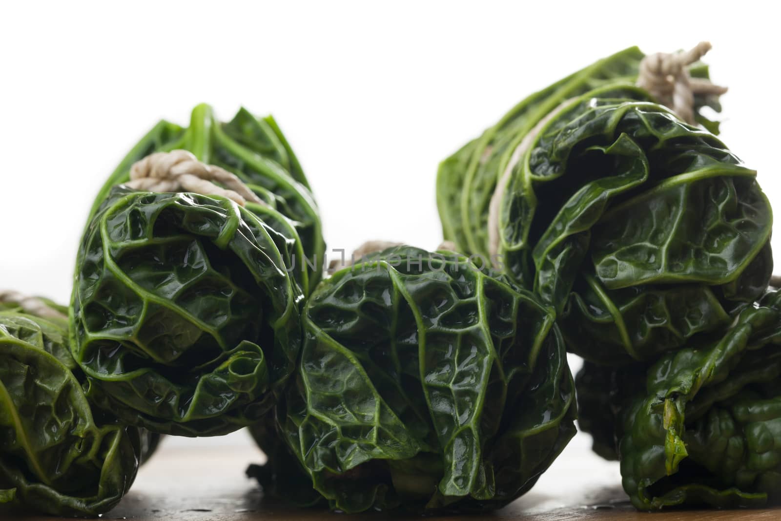 raw cabbage rolls on wood