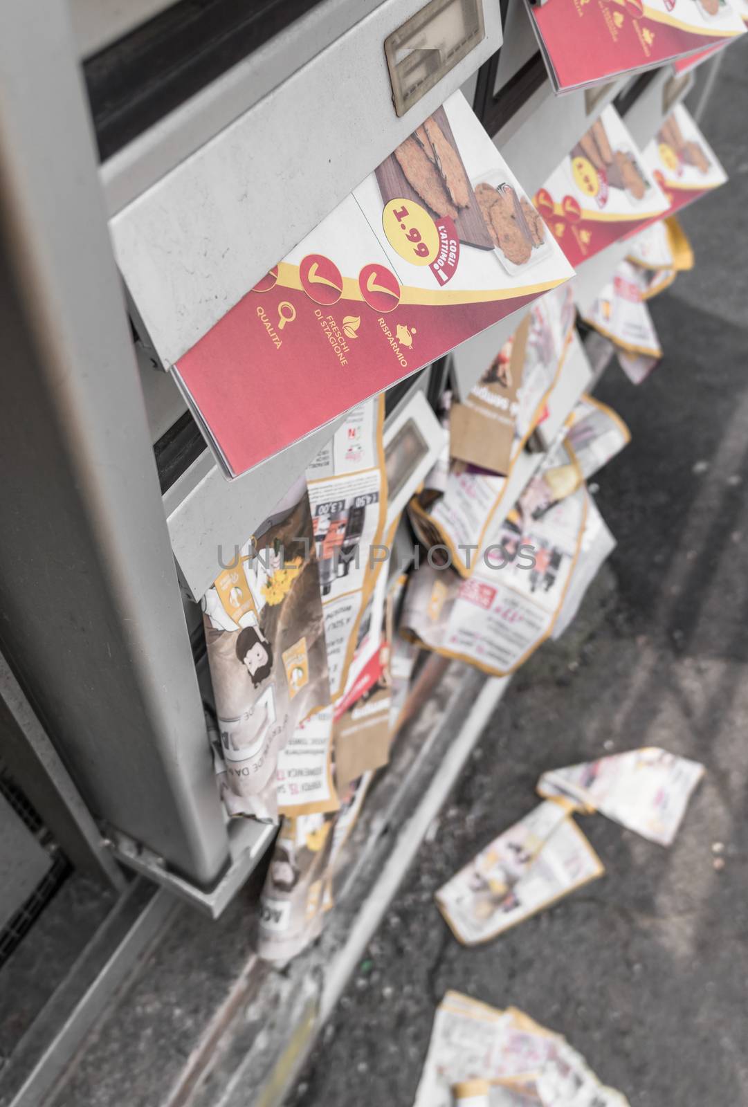 Many flyers in mailboxes, symbol for advertising, marketing, spam. Selective focus.
