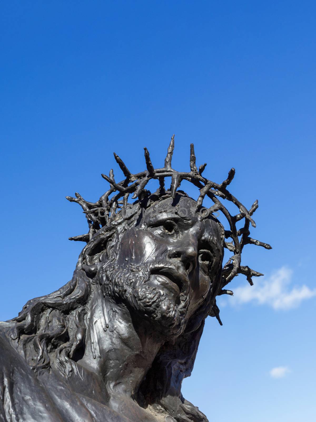 Bronze statue of Jesus Christ. Copy space.. Jesus looks up to heaven. Space for the text.