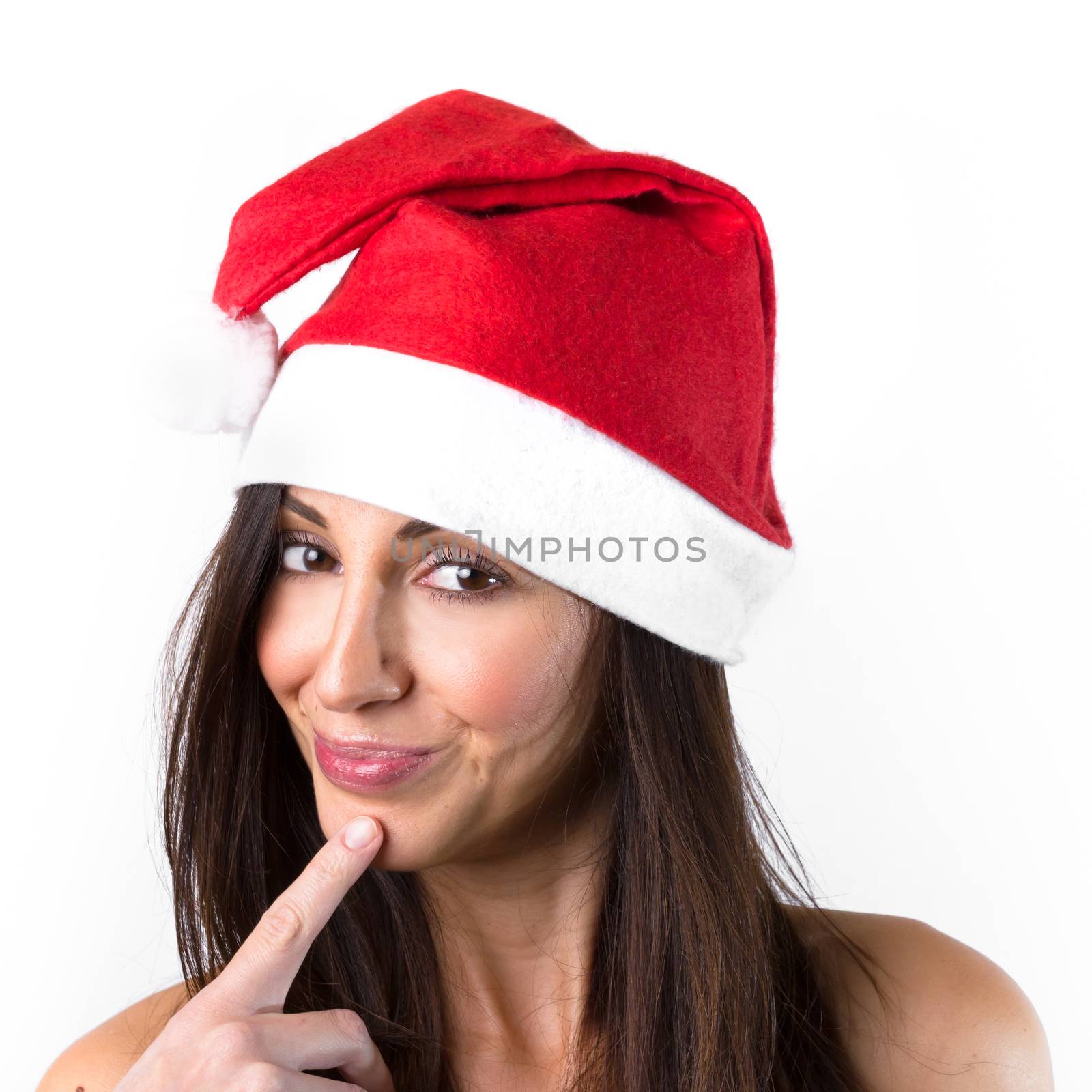 Gorgeous sexy young woman with bare shoulders in a red Santa Calus hat with natural make-up, isolated on white.