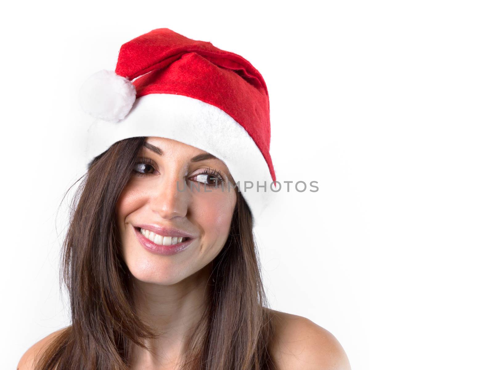 Smiling woman in Santa Claus hat looking towards white backgroun by germanopoli