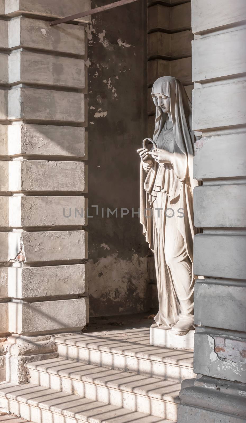 Statue in stone of Virgin Mary by germanopoli