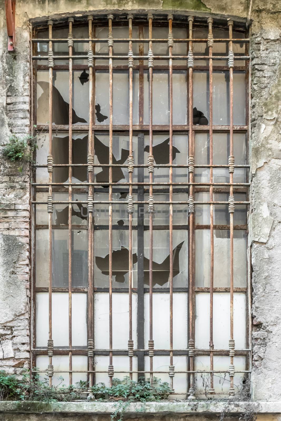 Old factory windows. Industrial photo. Amazing glass window texture. Abandoned building with beautiful old italian industry architecture.