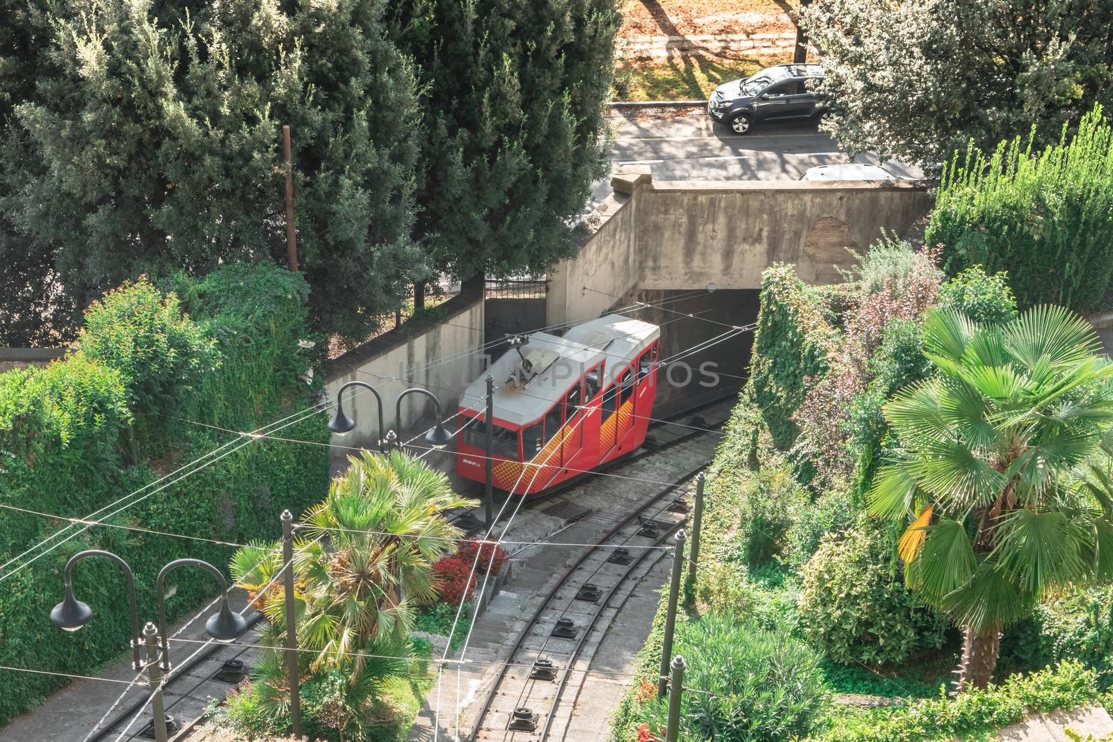 Upper city funicular line in Bergamo (Funicolare Citta Alta). Red funicular connects old Upper City and new. Scenic view of Bergamo historical center. Bergamo (upper town), ITALY - October 5, 2019