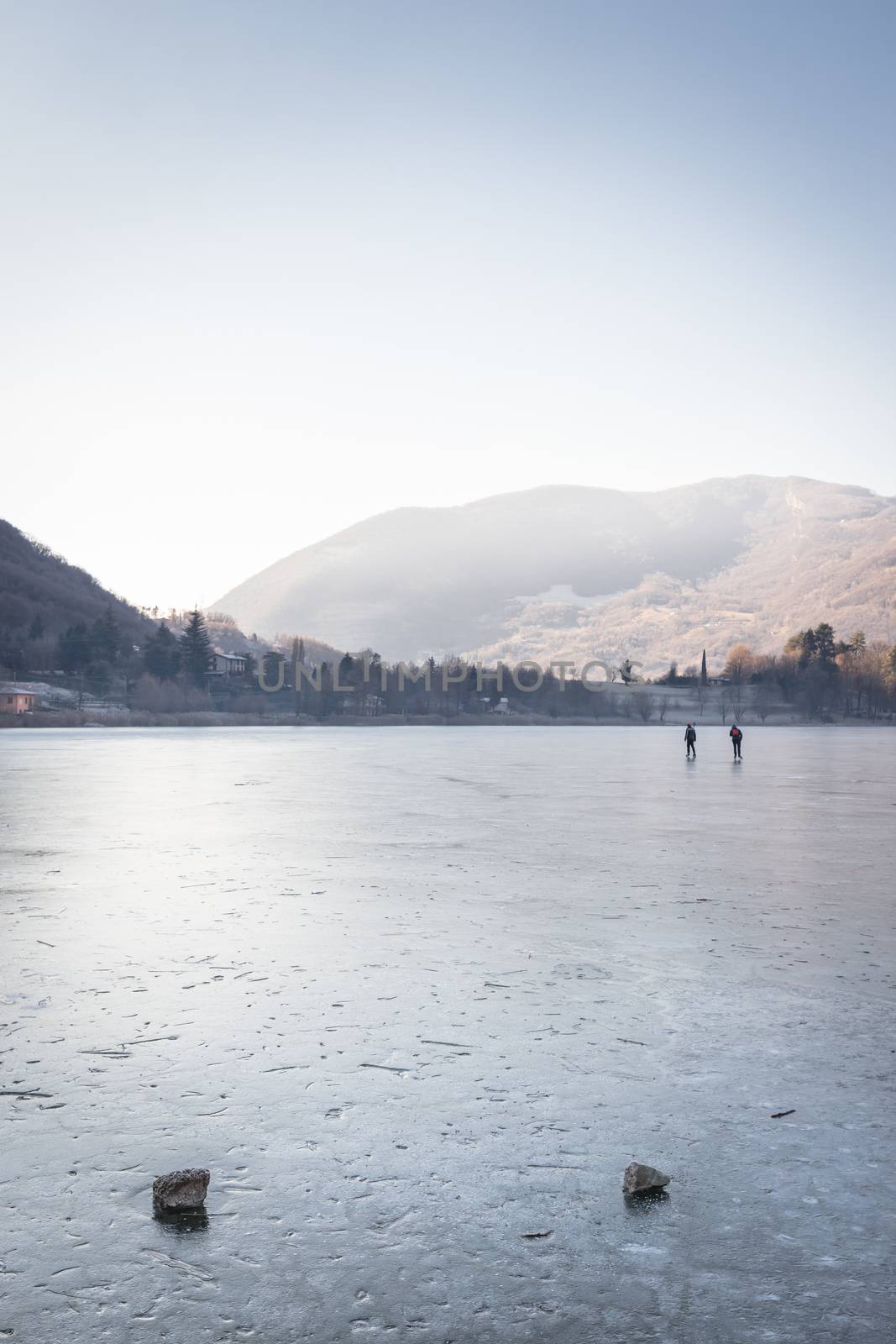 People skating on the Endine frozen lake by germanopoli