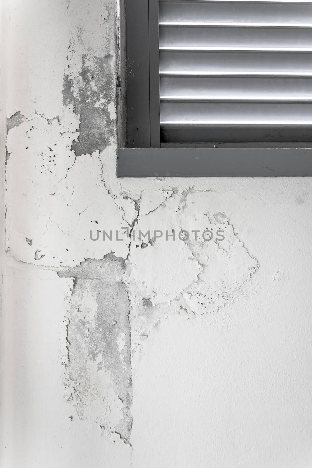 Peeling painted wall, texture, grunge background, cracked paint with white wall with window.