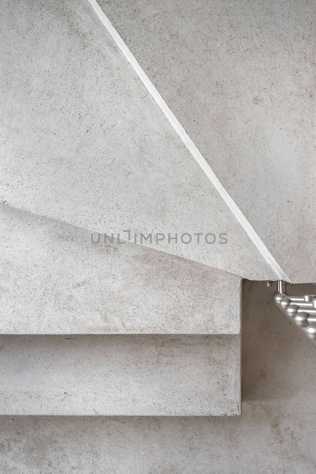Grey microcement stairs. Stairs viewed from above. Modern design and innovative material. Close - up.