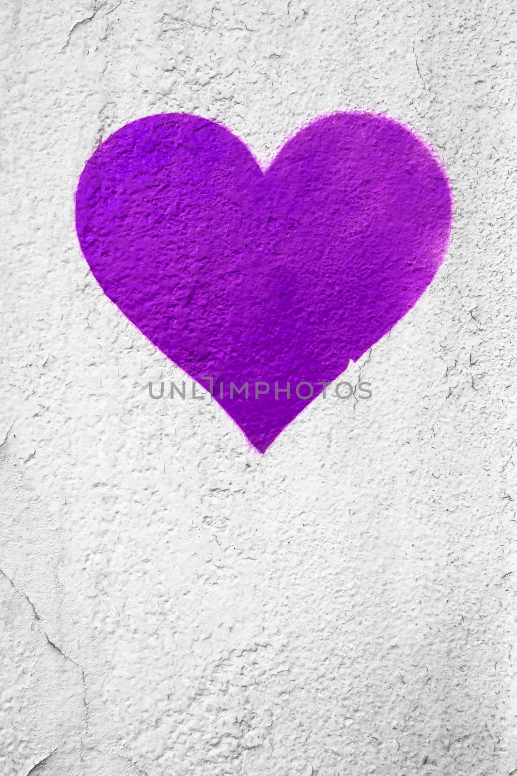 Purple love heart hand drawn on grungy wall. Textured background trendy street style. Copy space.