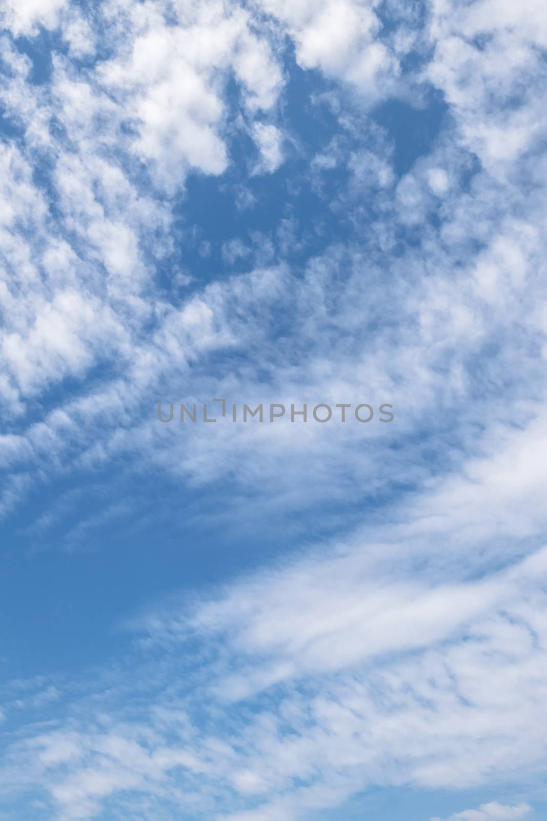 Blue sky background with fluffy white clouds