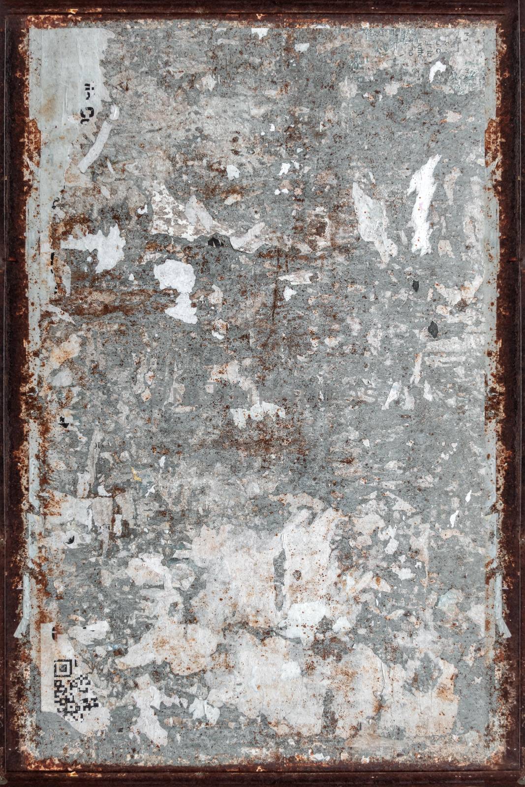 Texture of a grungy wall with torn posters and rusty frame. Ideal for textures and backgrounds. Retro style.