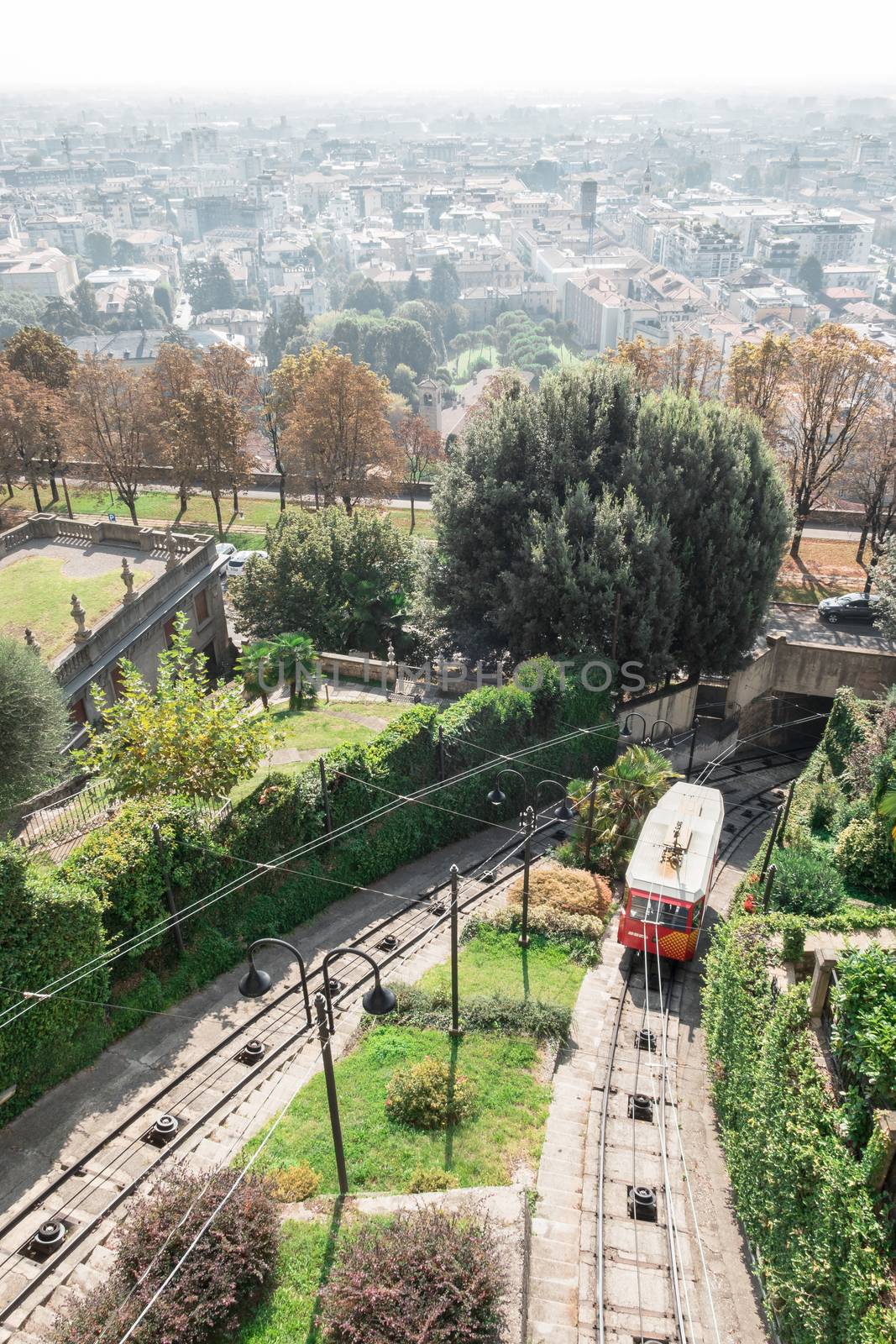 Red funicular in the old city of Bergamo by germanopoli