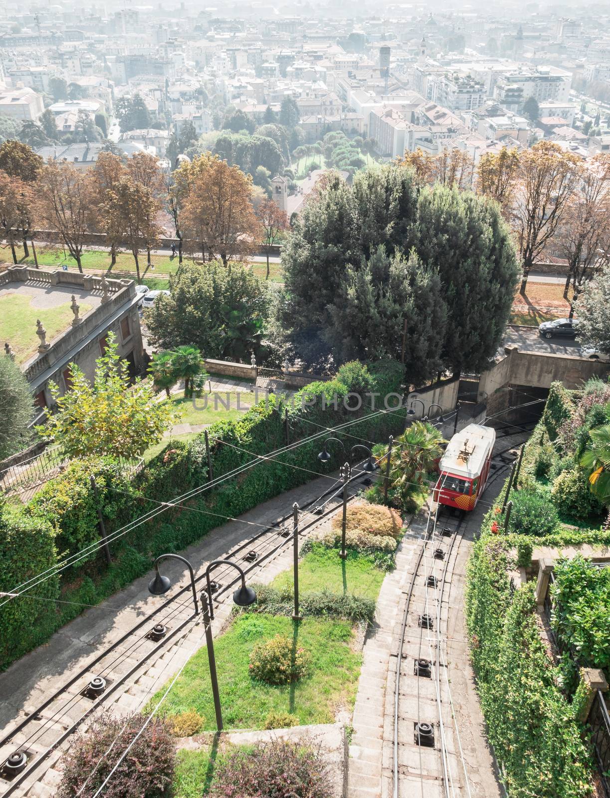 Upper city funicular line in Bergamo (Funicolare Citta Alta). Red funicular connects old Upper City and new. Scenic view of Bergamo historical center. Bergamo (upper town), ITALY - October 5, 2019