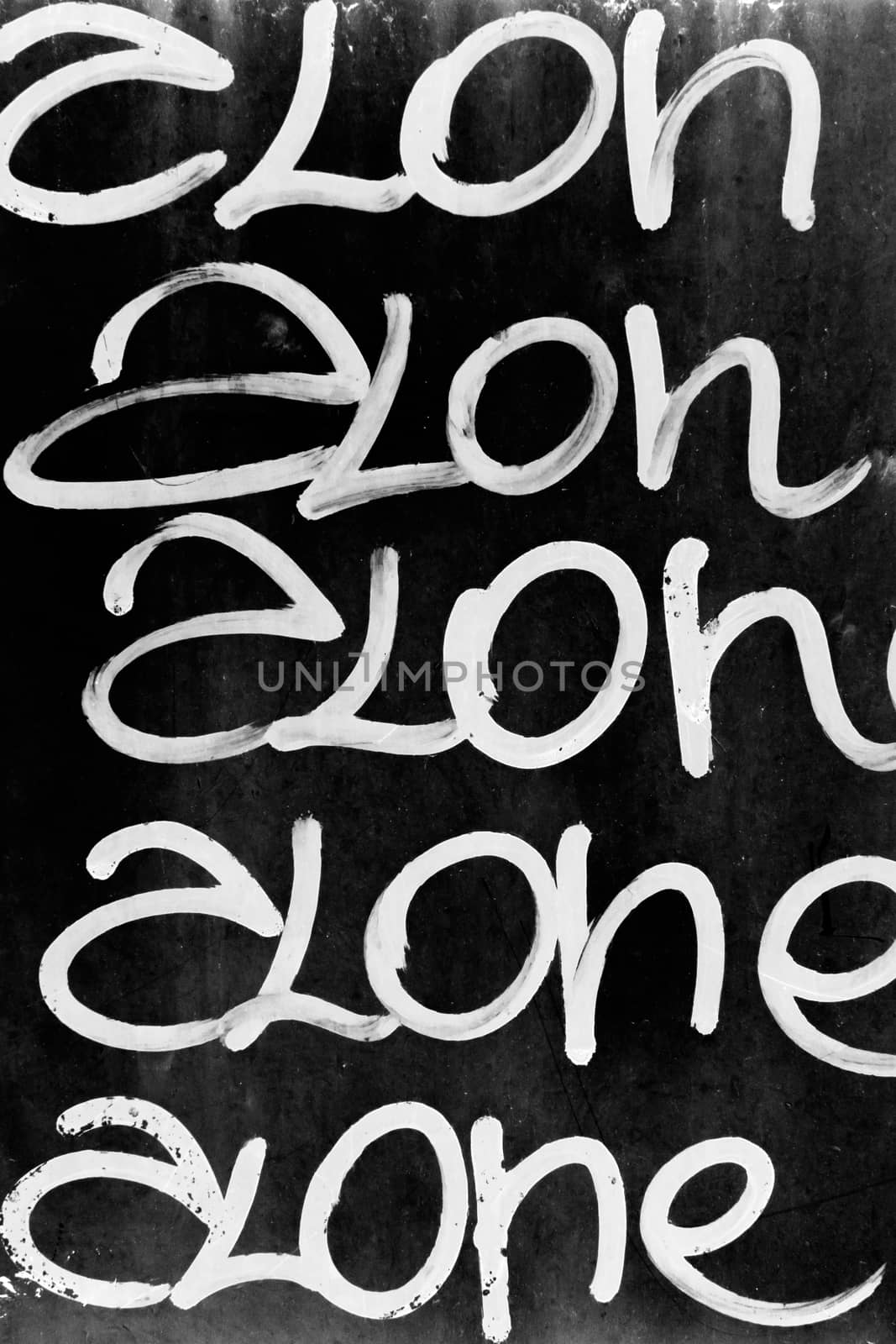 Word "alone" written on black grungy wall. It can be used as a poster, wallpaper, design t-shirts and more.